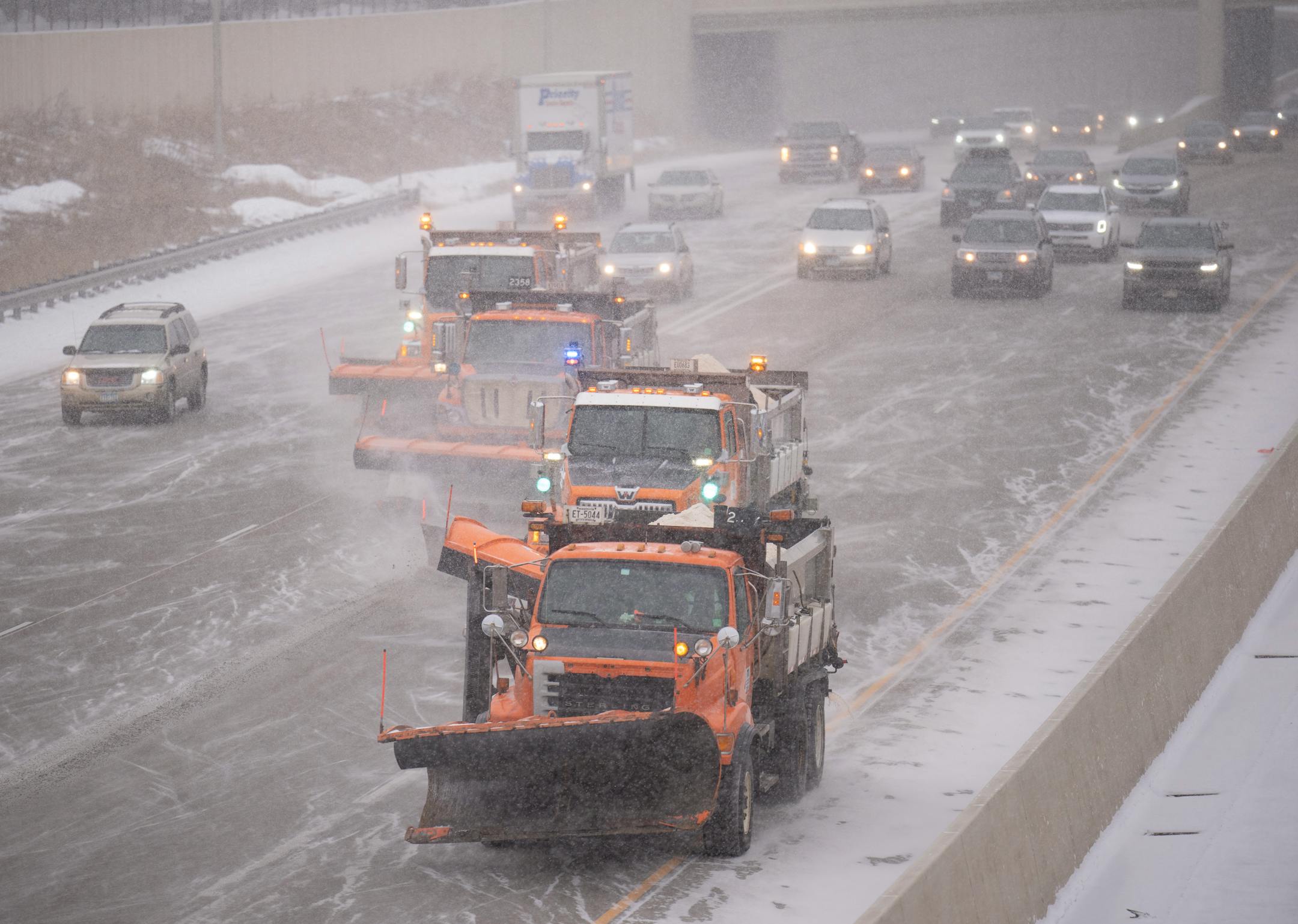 Minnesota Department of Transportation plows put down salt on I-35W just south of downtown Minneapolis as a winter storm hit the Twin Cities Tuesday afternoon.