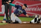 Mariners infielder Dylan Moore, left, tags out Yankees' Jon Berti during the eighth inning Monday night in New York.