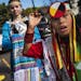 With the school mascot in the background, Styler Kuczaboksi,17, and WakinyanDeCory,9, are ambassadors who marched with the other children to Mounds Pa