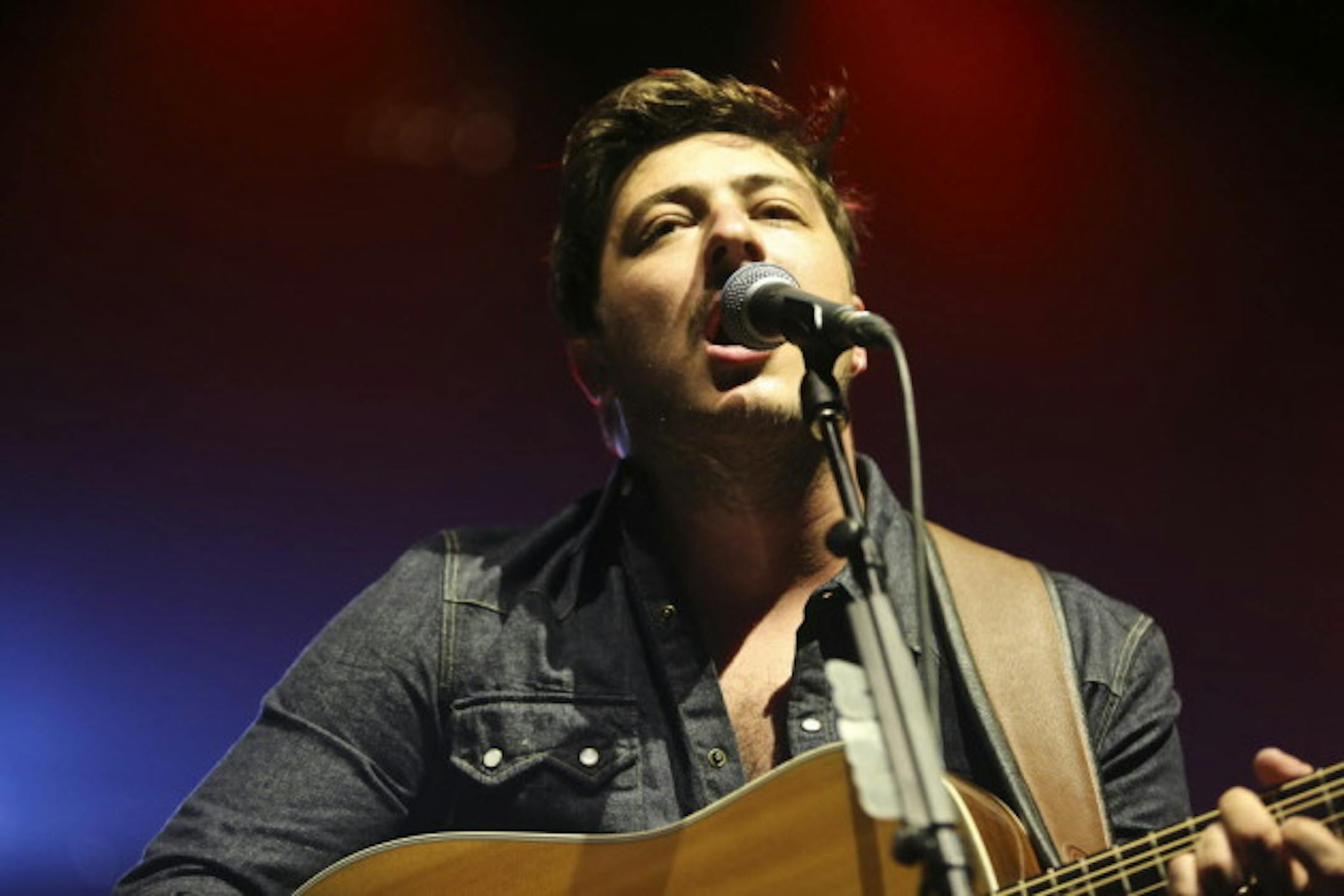 Marcus Mumford spent most of the night out front, but he did get behind a drum kit for two songs during Wednesday's concert at Xcel Energy Center. / Renee Jones Schneider, Star Tribune