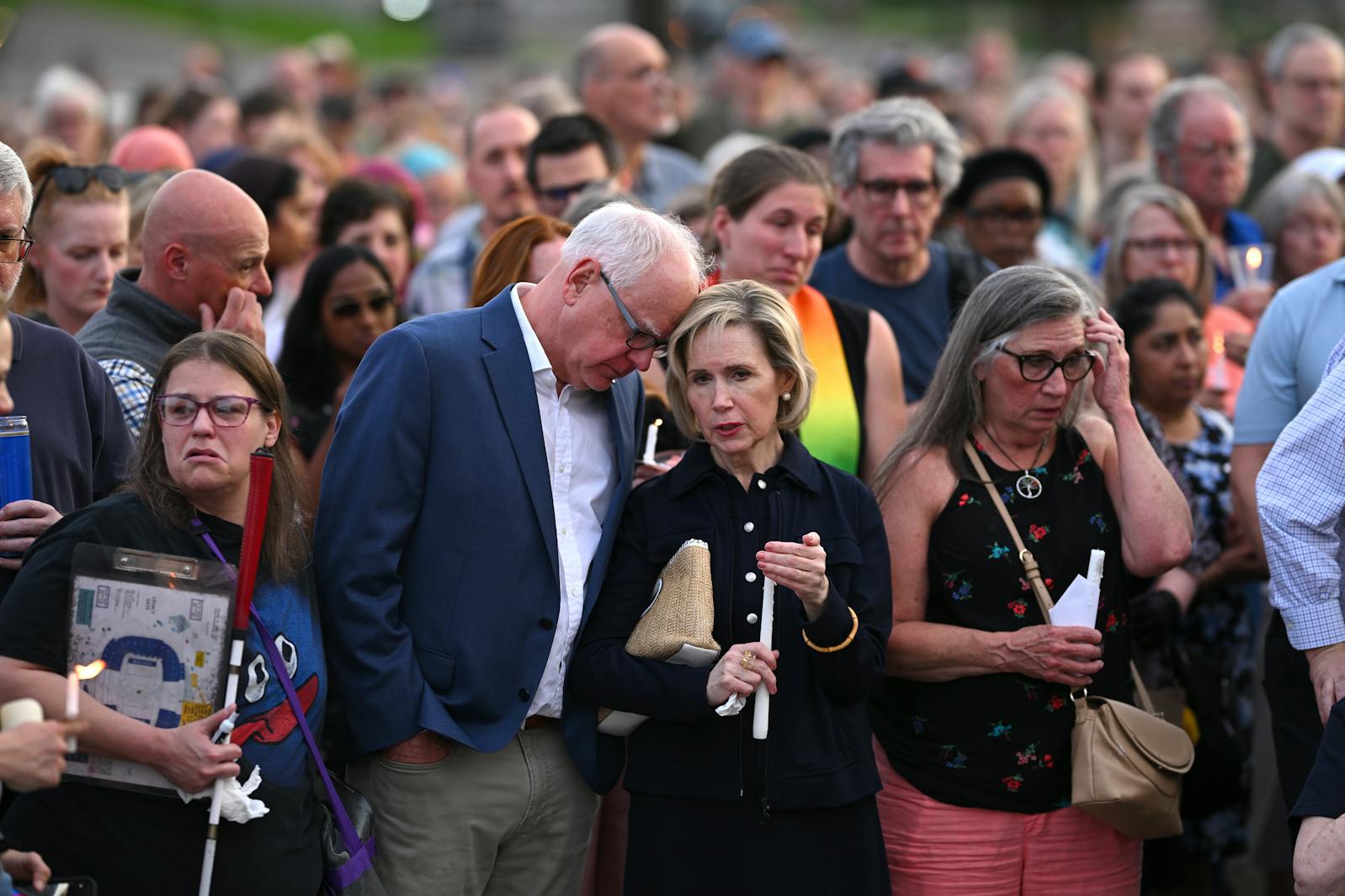 Gov. Tim Walz and wife Gwen stand with the crowd during a candlelight vigil for Melissa and Mark Hortman at the State Capitol building in St Paul on Wednesday.

