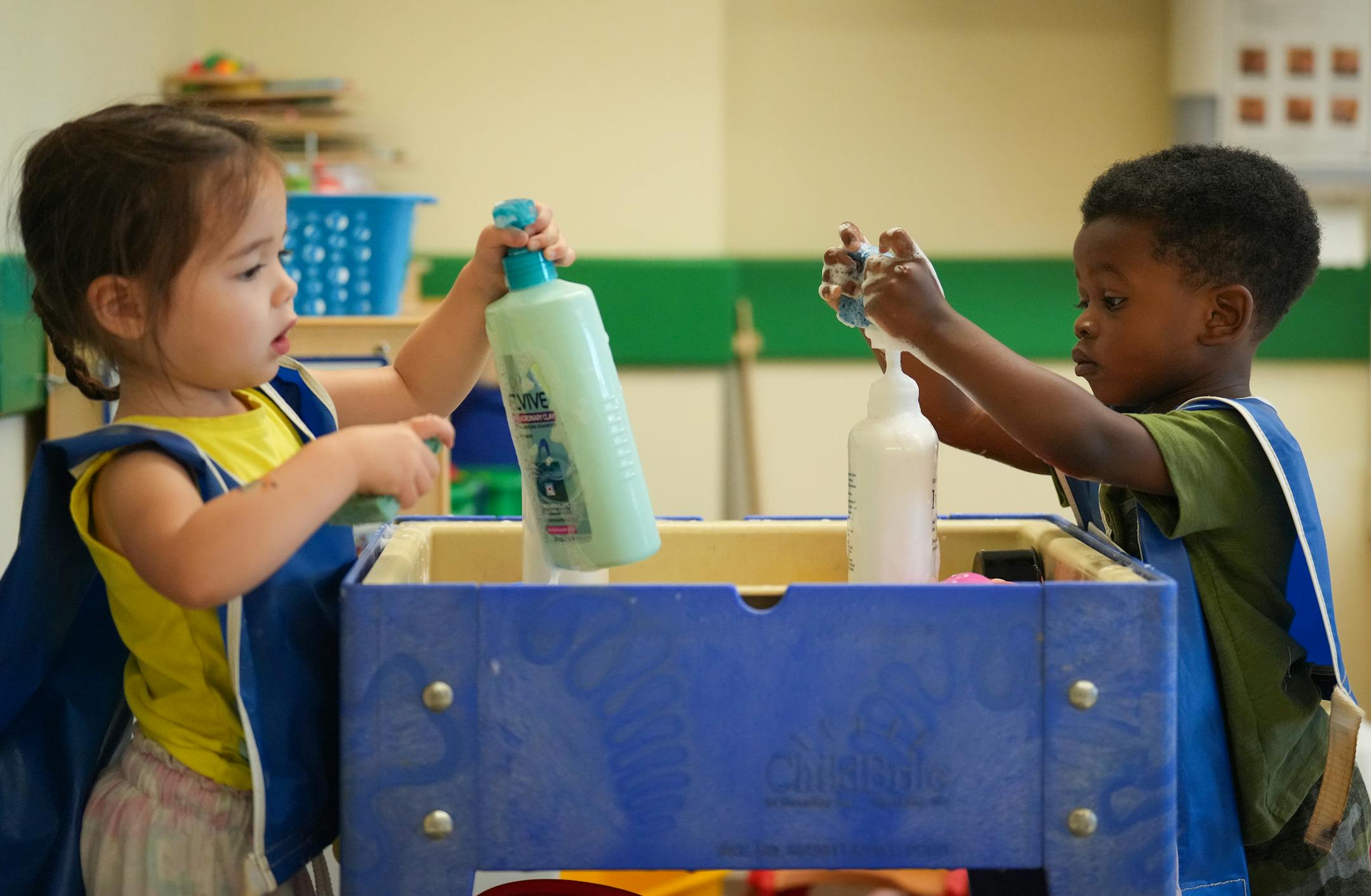 Students play at the soap station in the class of two-year-olds at Primrose School in Champlin Park, Minn.