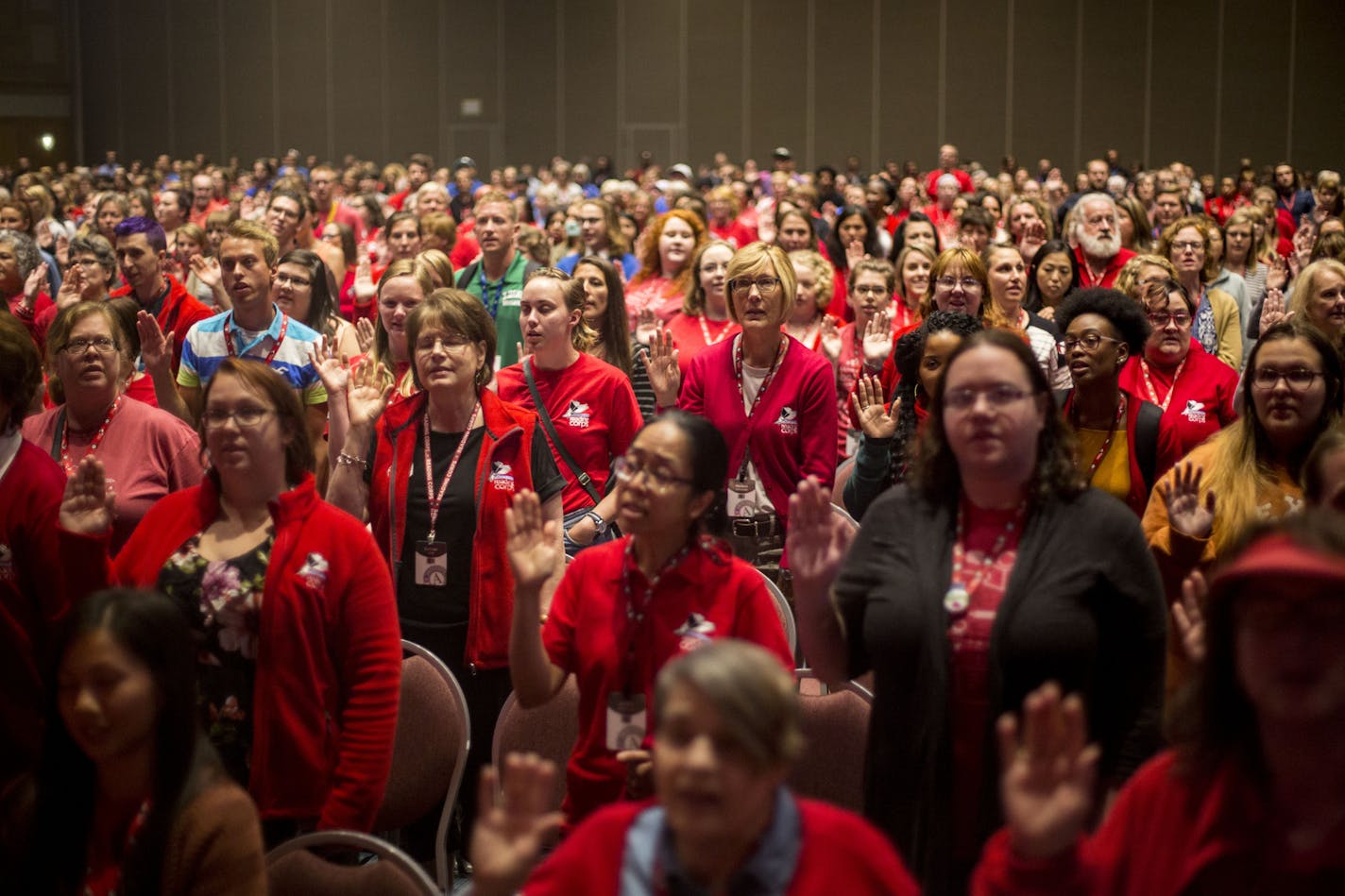 A group of Americorps tutors raised their right hands as they took the Americorps pledge. ] ALEX KORMANN &#xa5; alex.kormann@startribune.com Americorps held their largest pledge ceremony in Minnesota history at the Minneapolis Convention Center on Tuesday. Approximately 1,000 teachers gathered to receive training and take the pledge to to help guide children around the country for the next year. The group all also received a free copy of the Paul Reynolds book, "Going Places".