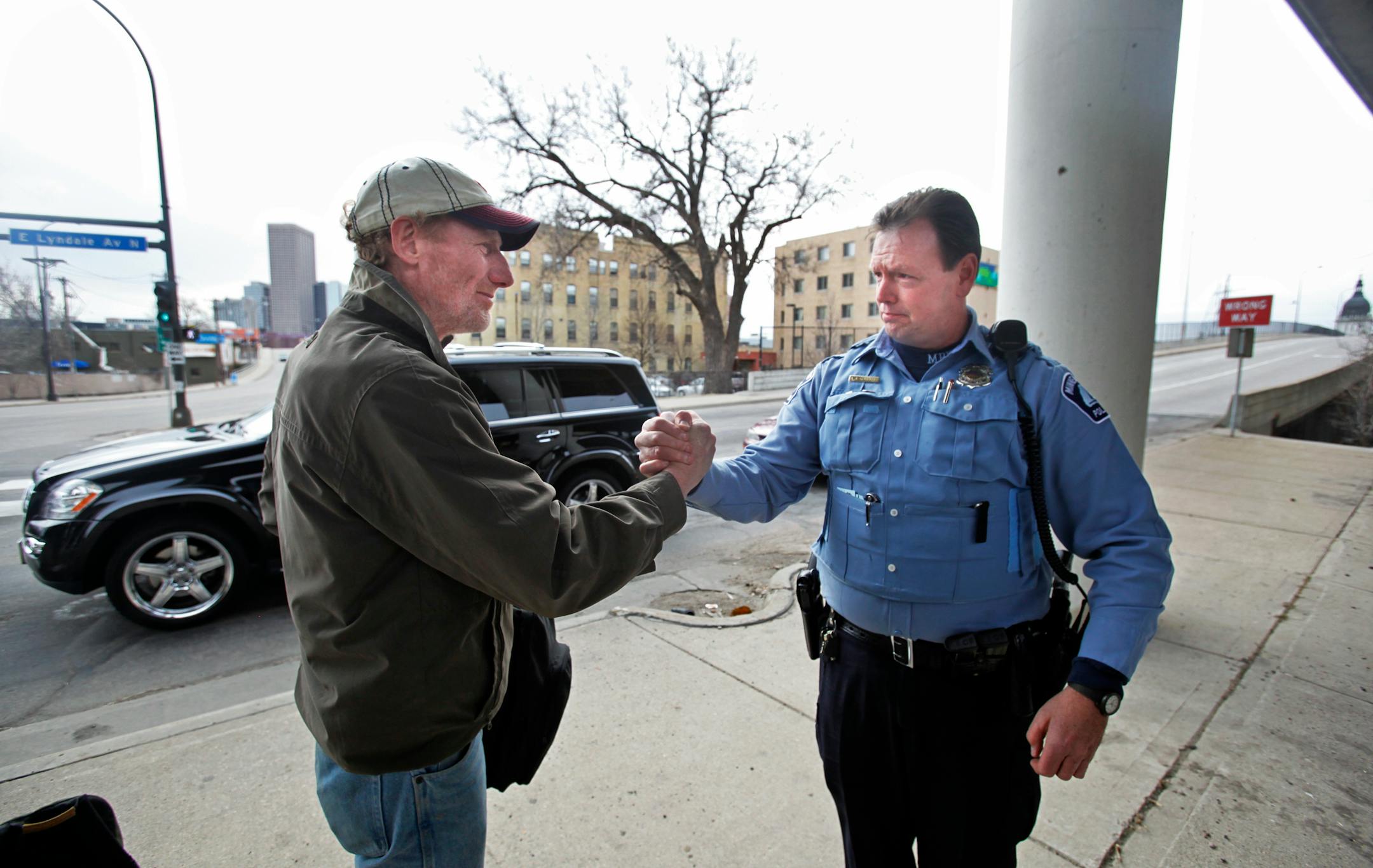 Police officer Adam Grobove shook hands with Bill Hitchcock, a homeless veteran, in downtown Minneapolis.