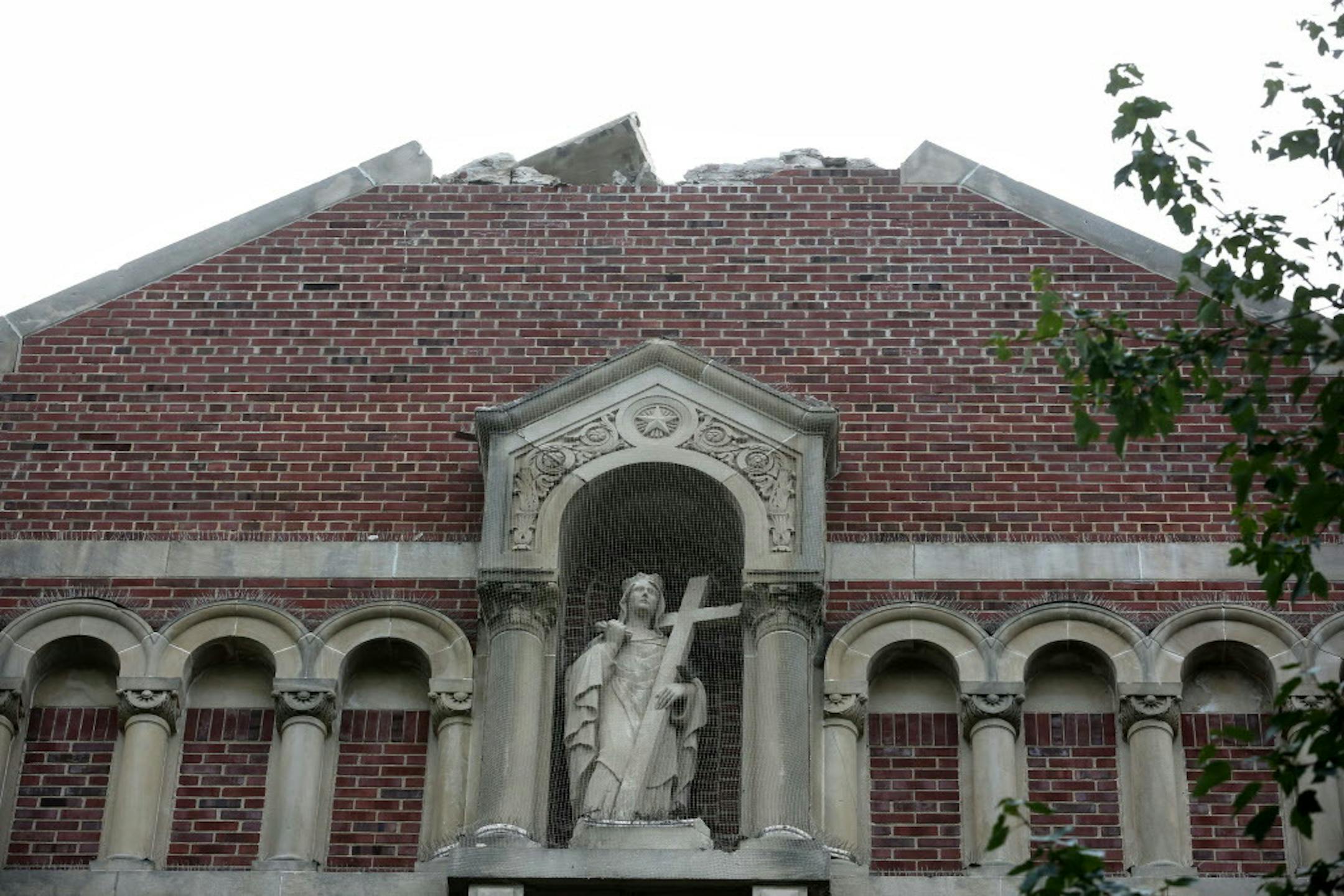 The cross on top of St. Helena Catholic was hit by lighting and exploded, leaving cracked tile and scattered debris around the south Minneapolis church.