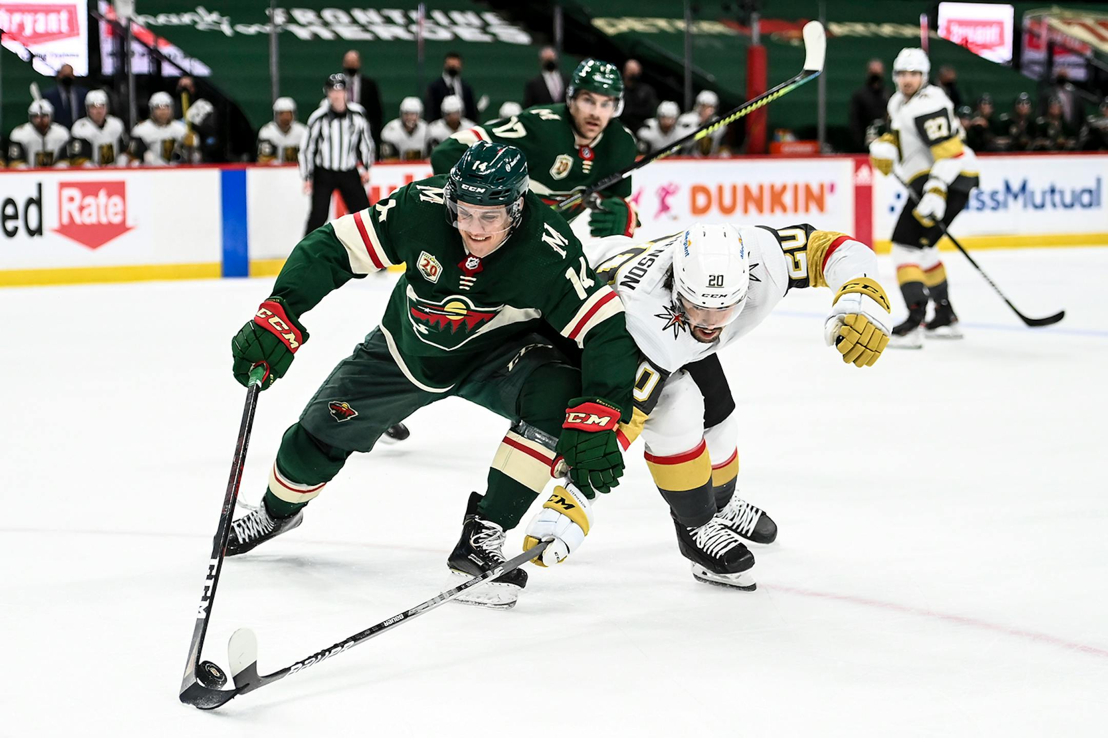 Minnesota Wild center Joel Eriksson Ek (14) and Vegas Golden Knights center Chandler Stephenson (20) vied for control of the puck in the second period.