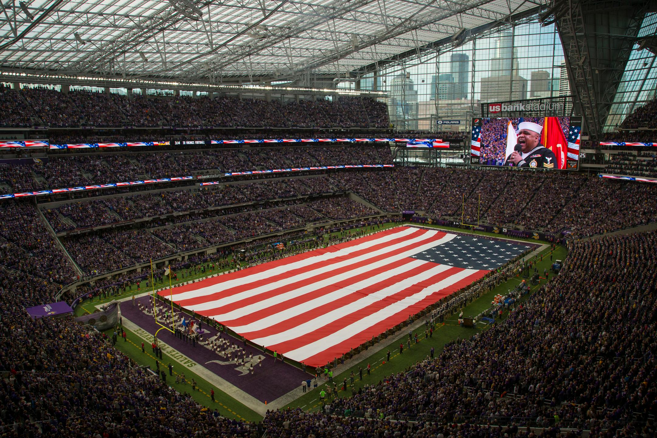 A football-field sized flag covered was unfurled over the field during the national anthem as part of the Vikings and NFL's Salute to Service before Sunday's game against the Rams.