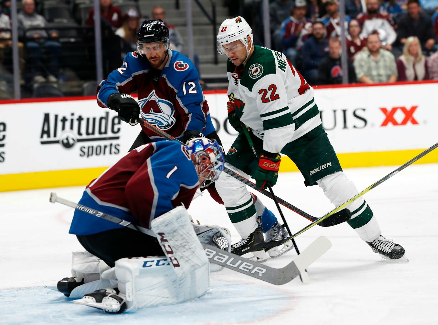 Colorado goaltender Semyon Varlamov stops a shot by Wild right wing Nino Niederreiter as Avalanche defenseman Patrik Nemeth watches during the second period