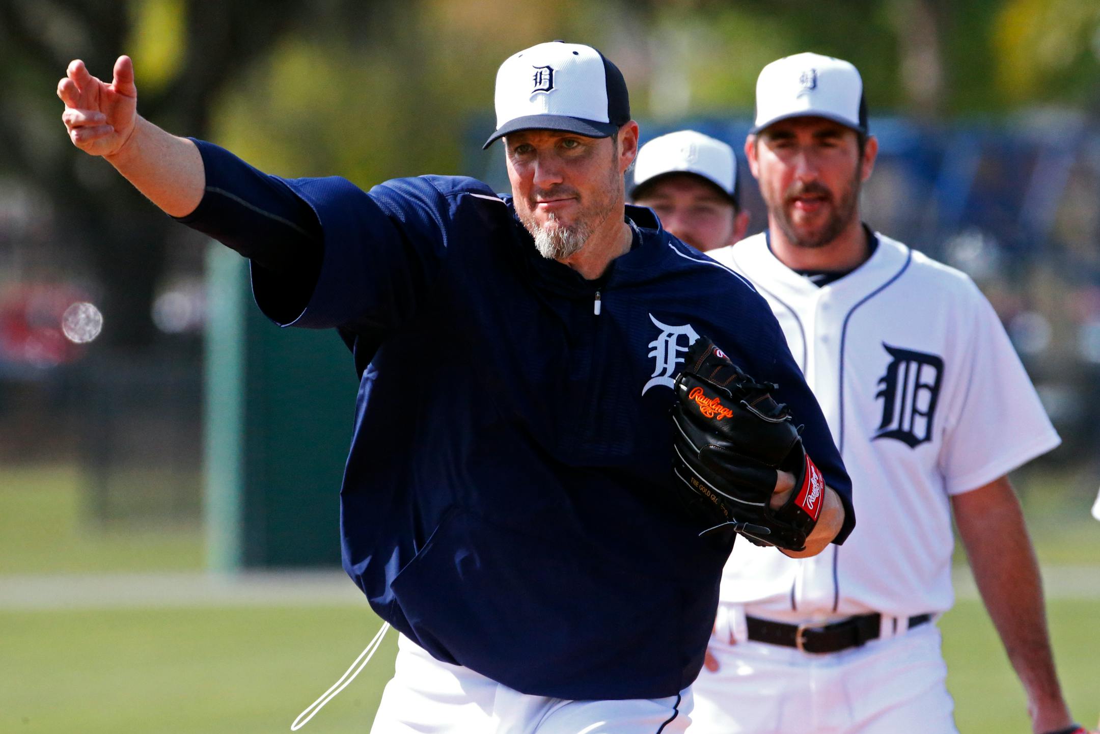 Detroit Tigers pitchers Joe Nathan, left, and Justin Verlander participate in a drill during a baseball spring training workout in Lakeland, Fla., Saturday, Feb. 21, 2015. (AP Photo/Gene J. Puskar)