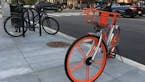 A dockless bike is left near a busy intersection on U Street in Washington, D.C. The city, which has its own bike-share program, has welcomed dockless
