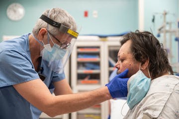 Dr. Todd Struckman examined Neil Adamson, who was experiencing throat swelling, on Thursday at St. Luke’s in Duluth.