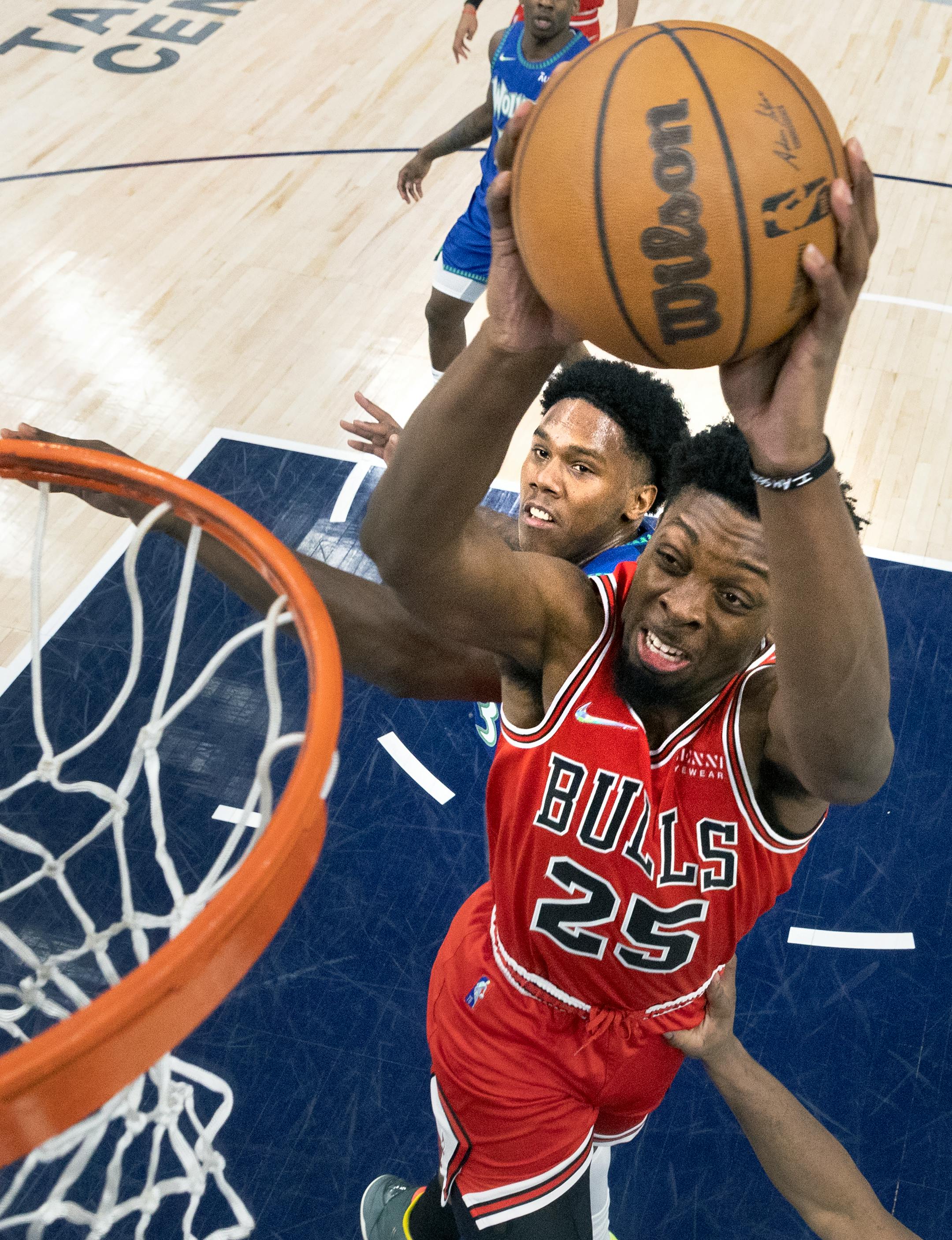 Tyler Cook (25) of the Chicago Bulls attempts a shot while defended by Nathan Knight (13) of the Minnesota Timberwolves.