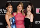 In this Feb. 28, 2019 file photo, actress Lori Loughlin, center, poses with daughters Olivia Jade Giannulli, left, and Isabella Rose Giannulli at the 
