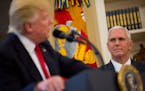 FILE -- Vice President Mike Pence looks at President Donald Trump in the Oval Office of the White House in Washington, March 31, 2017. Pence appears t
