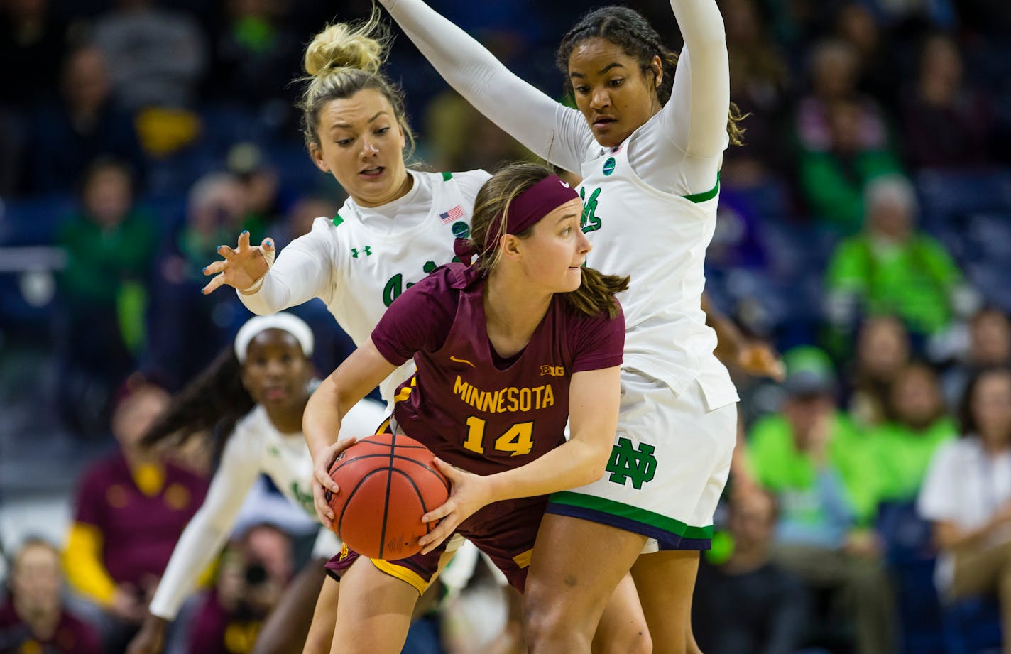 Notre Dame's Kaitlin Cole (2) and Anaya Peoples (21) defend Minnesota's Sara Scalia on Wednesday in South Bend