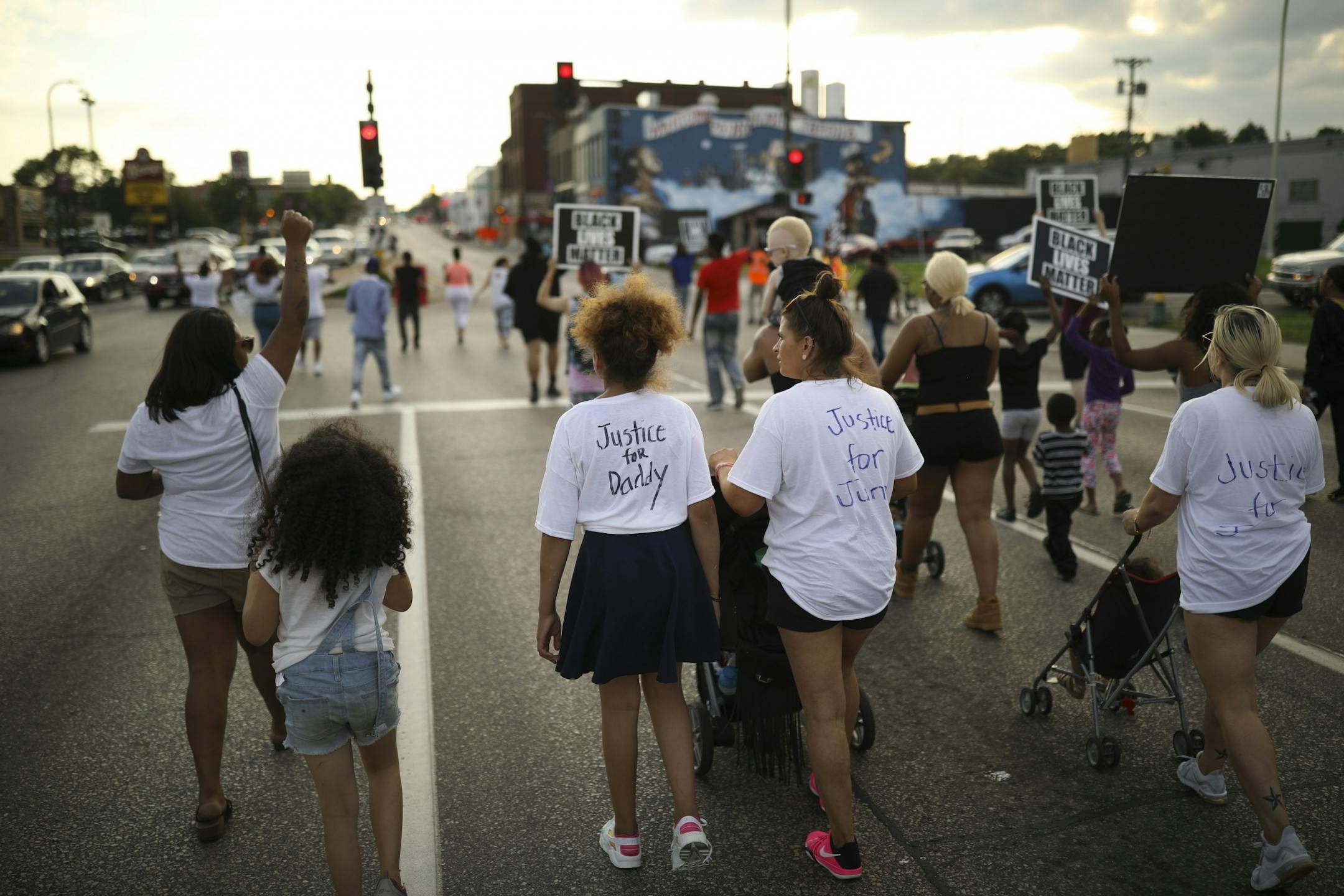 Peace walkers headed back west on W. Broadway Ave. after briefly blocking the intersection with Washington Ave. N.