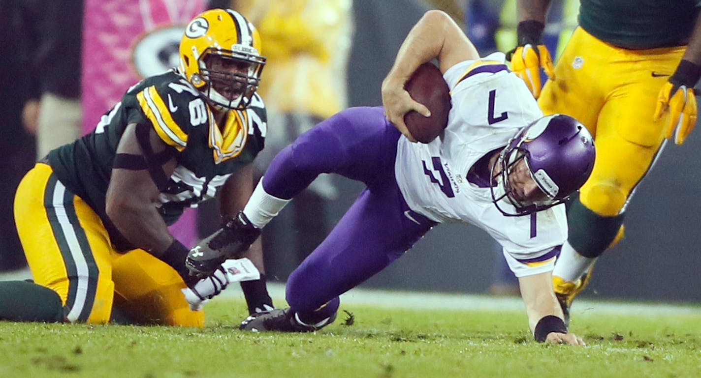 Minnesota Vikings quarterback Christian Ponder (7) was sacked by Green Bay Packers defensive end Mike Daniels (76) in the second quarter . The Minnesota Vikings played the Green Bay Packers Thursday October 2 , 2014 at Lambeau Field in Green Bay ,WI.