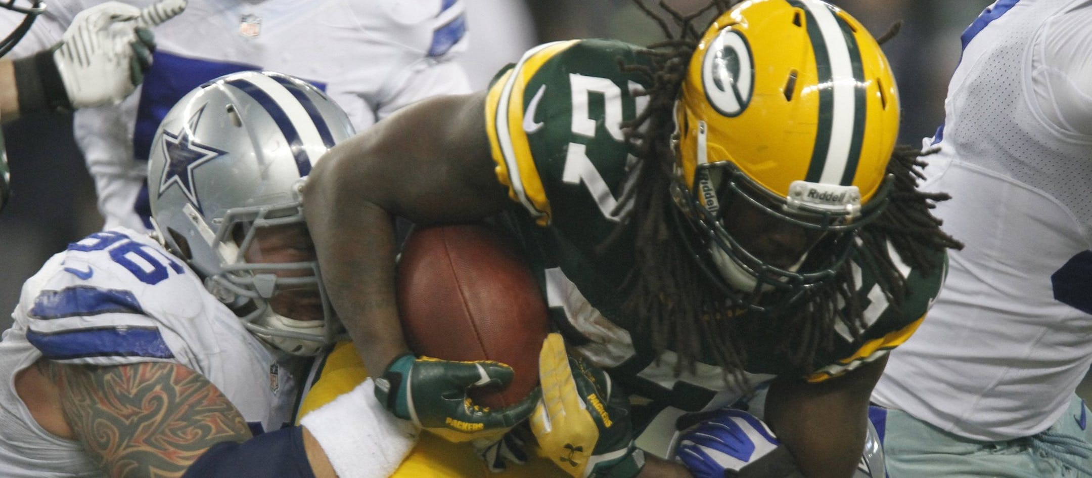 Dallas Cowboys defensive tackle Nick Hayden (96) and defensive end Everette Brown (71) bring down Green Bay Packers running back Eddie Lacy (27) after a short gain in the second quarter at AT&T Stadium in Arlington, Texas, on Sunday, Dec. 15, 2013. (David Kent/Fort Worth Star-Telegram/MCT)