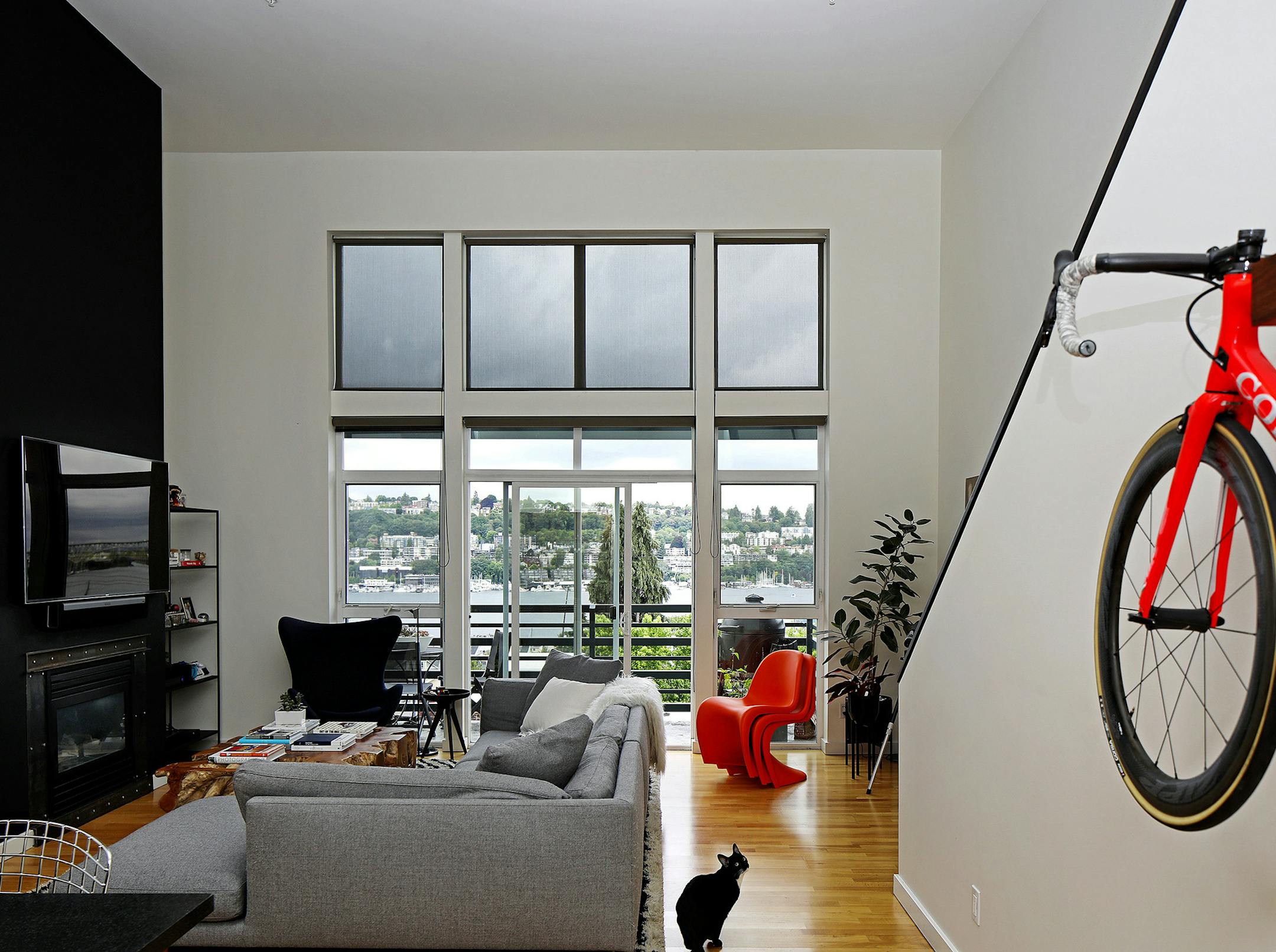 "From the black fireplace that extends from floor to ceiling to the black-and-white striped shag rug, [the pets] reflect the setting of the space," says interior designer Barbara Hyde Evans. This particular kitty is Bandita; homeowner Max Lemman and his girlfriend, Ashley, also have a black-and-white cat named Victoria, and a black-and-white puppy named Navi. (Ken Lambert/The Seattle Times/TNS)