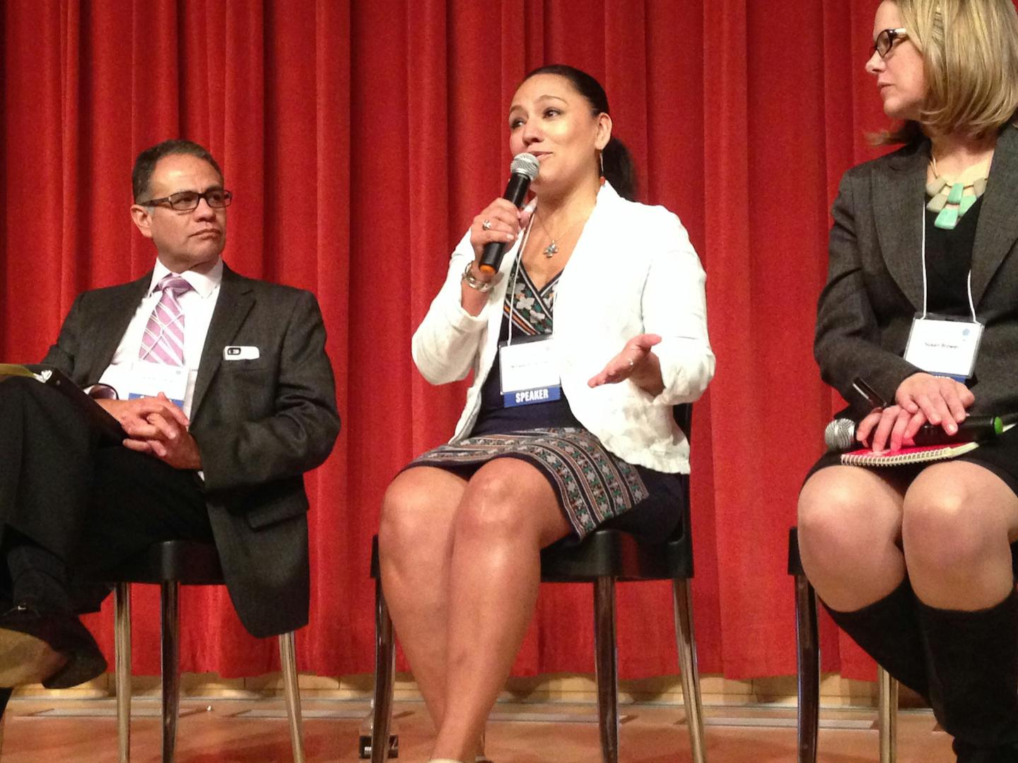 Milissa Silva-Diaz, chief executive of El Burrito Mercado in St. Paul, center, speaks at a Global Minnesota workshop on migration Friday at the downtown Minneapolis Public Library as Gerardo Guerrero, Consul of Mexico in St. Paul, left, and Susan Brower, Minnesota State Demographer, right, listen.