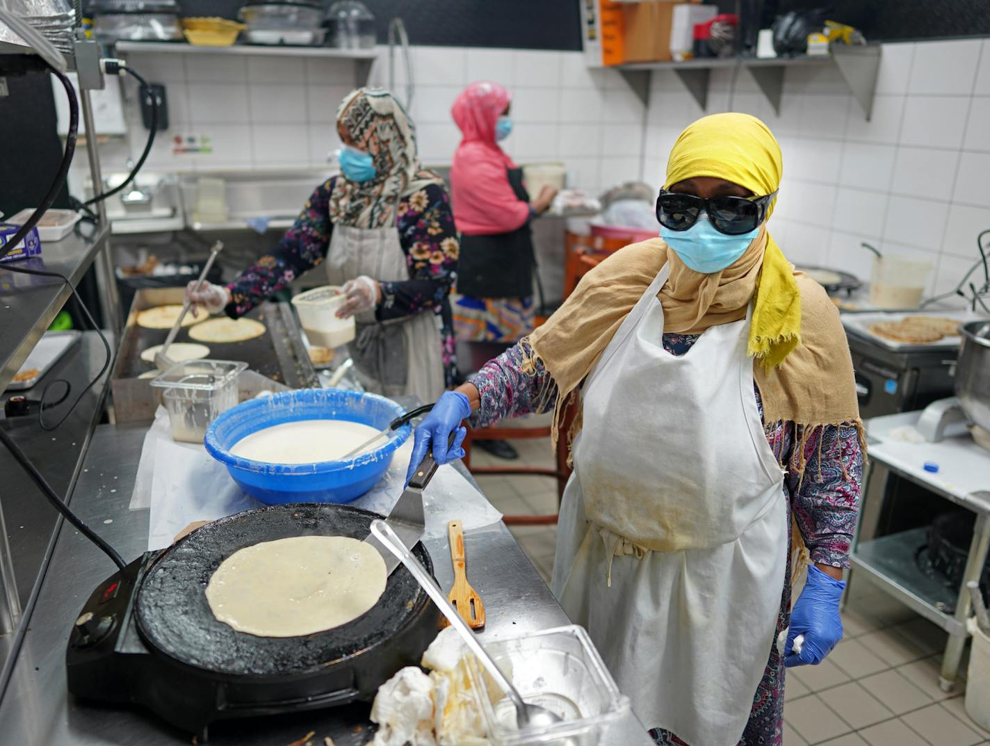 The Afro Deli, where workers continued to prepare meals, is staying in business with the help of a deal with Metro Meals on Wheels to provide 1,200 meals daily.