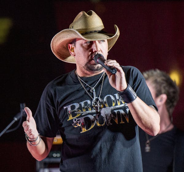 FILE - In this June 7, 2017 file photo Jason Aldean performs during a surprise pop up concert at the Music City Center in Nashville, Tenn. &#x201c;Sat