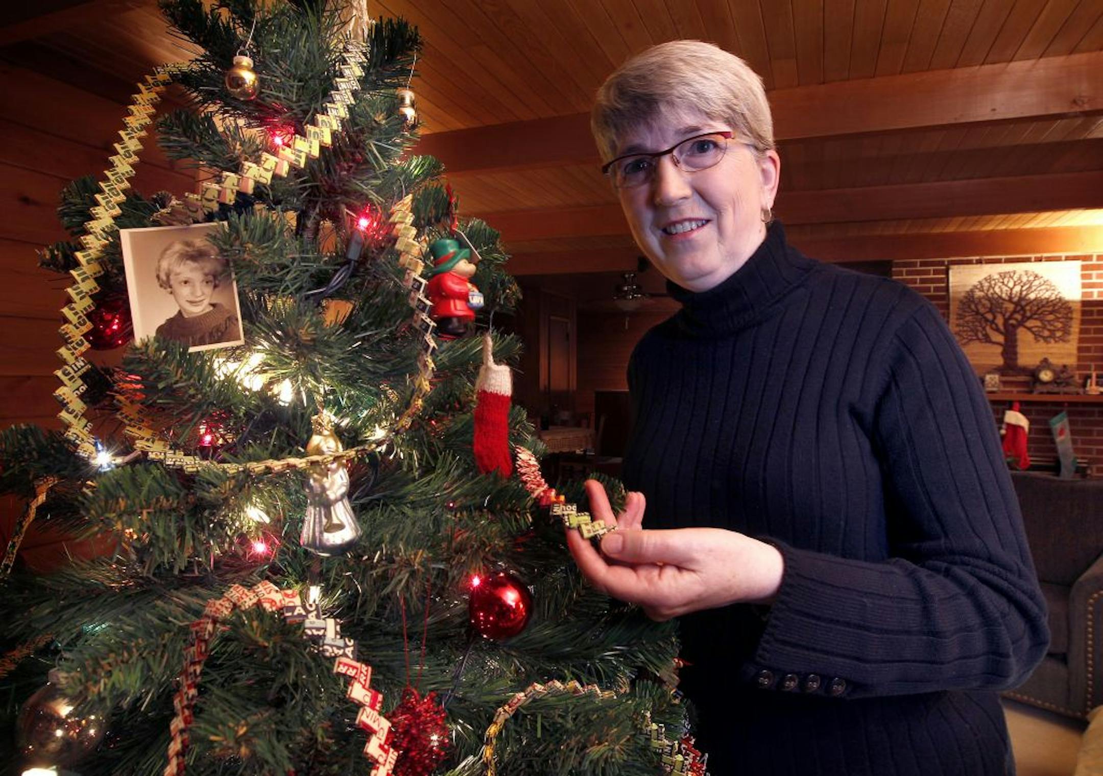 Julie Petersen wraps her Christmas tree with the gum-wrapper garland she and her friend Wendy, who died in a car crash while in her teens, made together. Wendy's photo hangs in the tree.