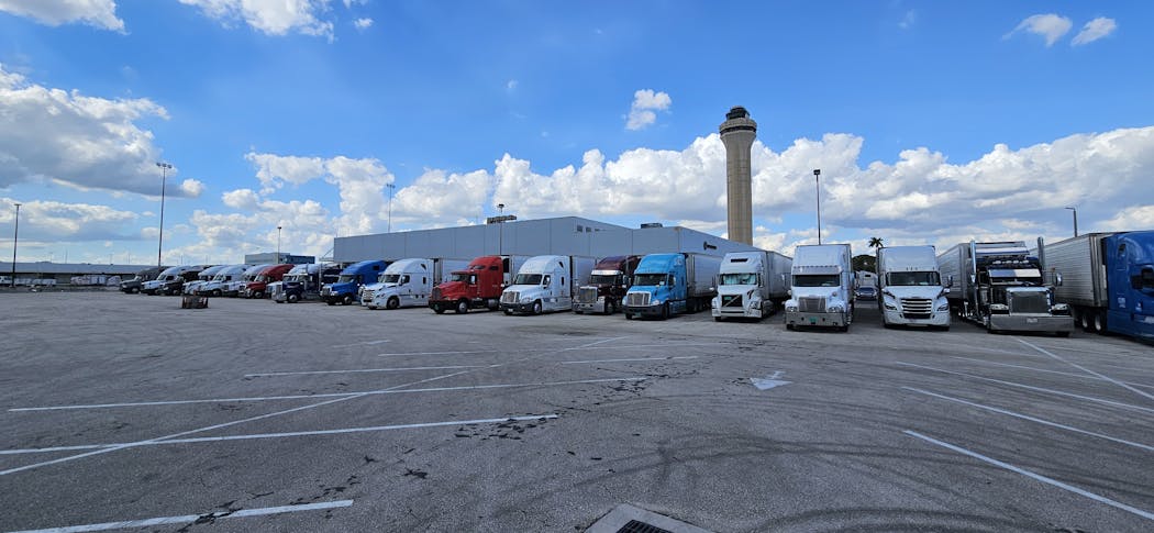 Refrigerated semitrailer trucks line up to transport cut flowers at C.H. Robinson's warehouse at the Miami airport.