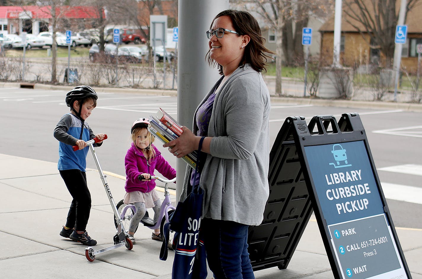 Lis Moriarty and her two children, Brenna, 4, and Liam, 5, walked from their home to the to the Ramsey County Library-Roseville, for curbside pickup and drop-off Thursday, April 23, 2020, in Roseville, MN.] DAVID JOLES &#x2022; david.joles@startribune.com No customer has stepped foot in a Ramsey County Library in a month but patrons are still checking out more than 1,000 books, magazines and DVDS each day thanks to the county's curbside pick-up program. While some counties quickly furloughed lib