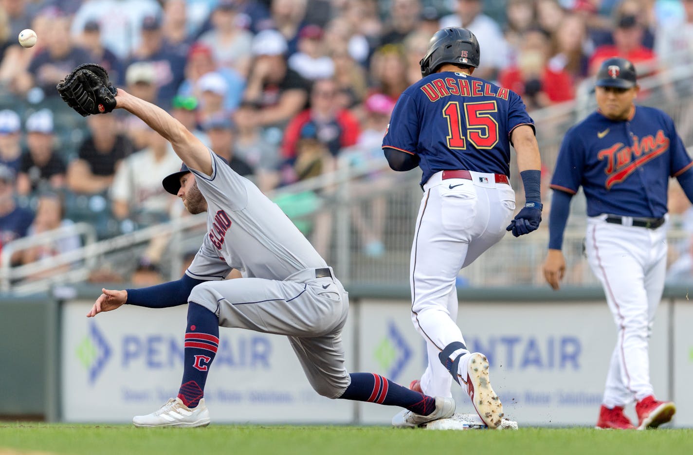 Cleveland Guardians first baseman Owen Miller (6) can't hang on to the ball as Gio Urshela (15) of the Minnesota Twins is safe in the second inning Wednesday, June 22, 2022, at Target Field in Minneapolis, Minn. ] CARLOS GONZALEZ • carlos.gonzalez@startribune.com