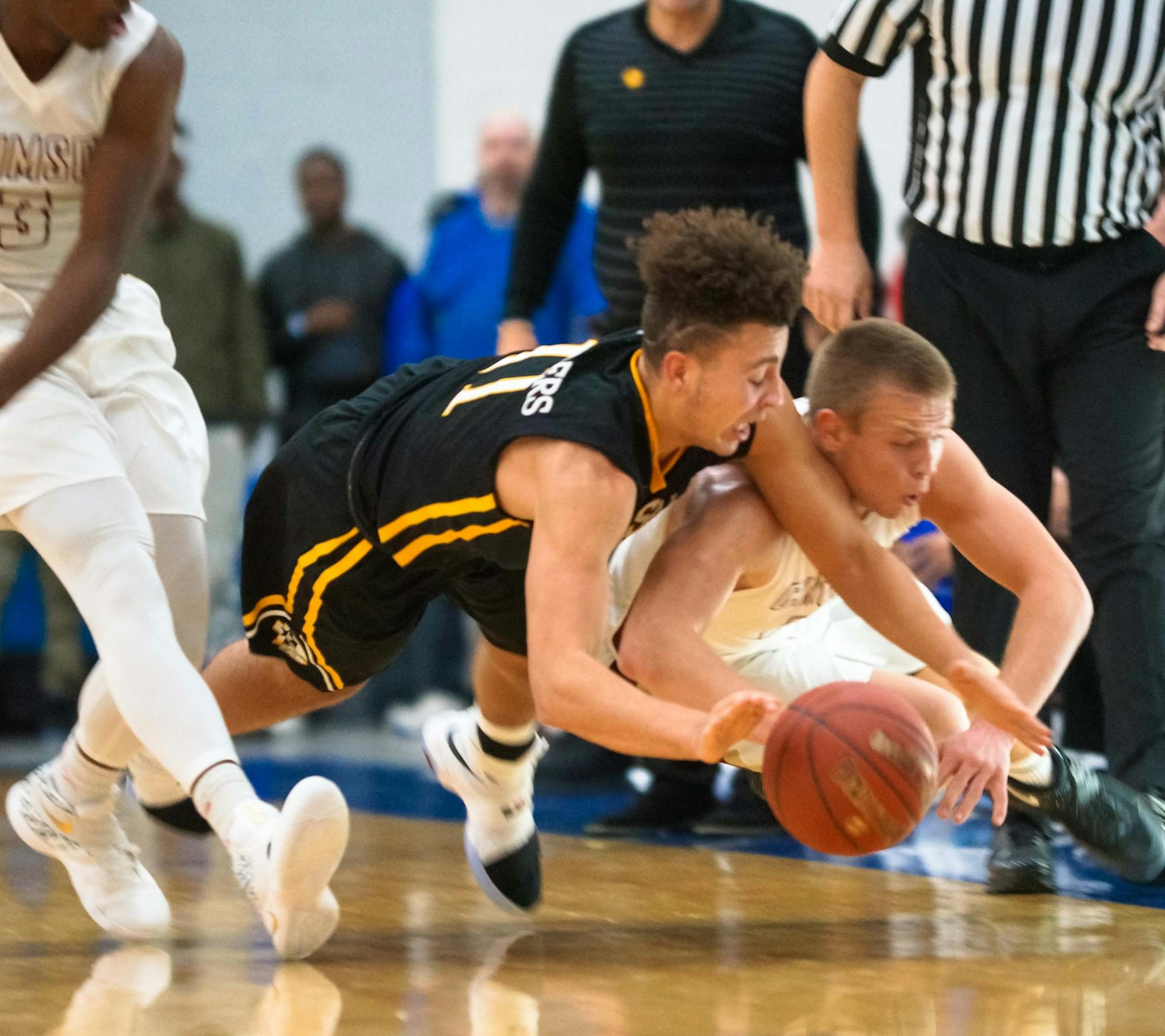 DeLaSalle junior guard Gabe Kalscheur battled for a loose ball in a Dec. 10 game against Maple Grove at Hopkins Lindbergh Center.