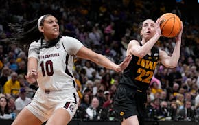 Iowa's Caitlin Clark shoots past South Carolina's Kamilla Cardoso during the 2023 Final Four in Dallas. Both players are expected to be top picks in t
