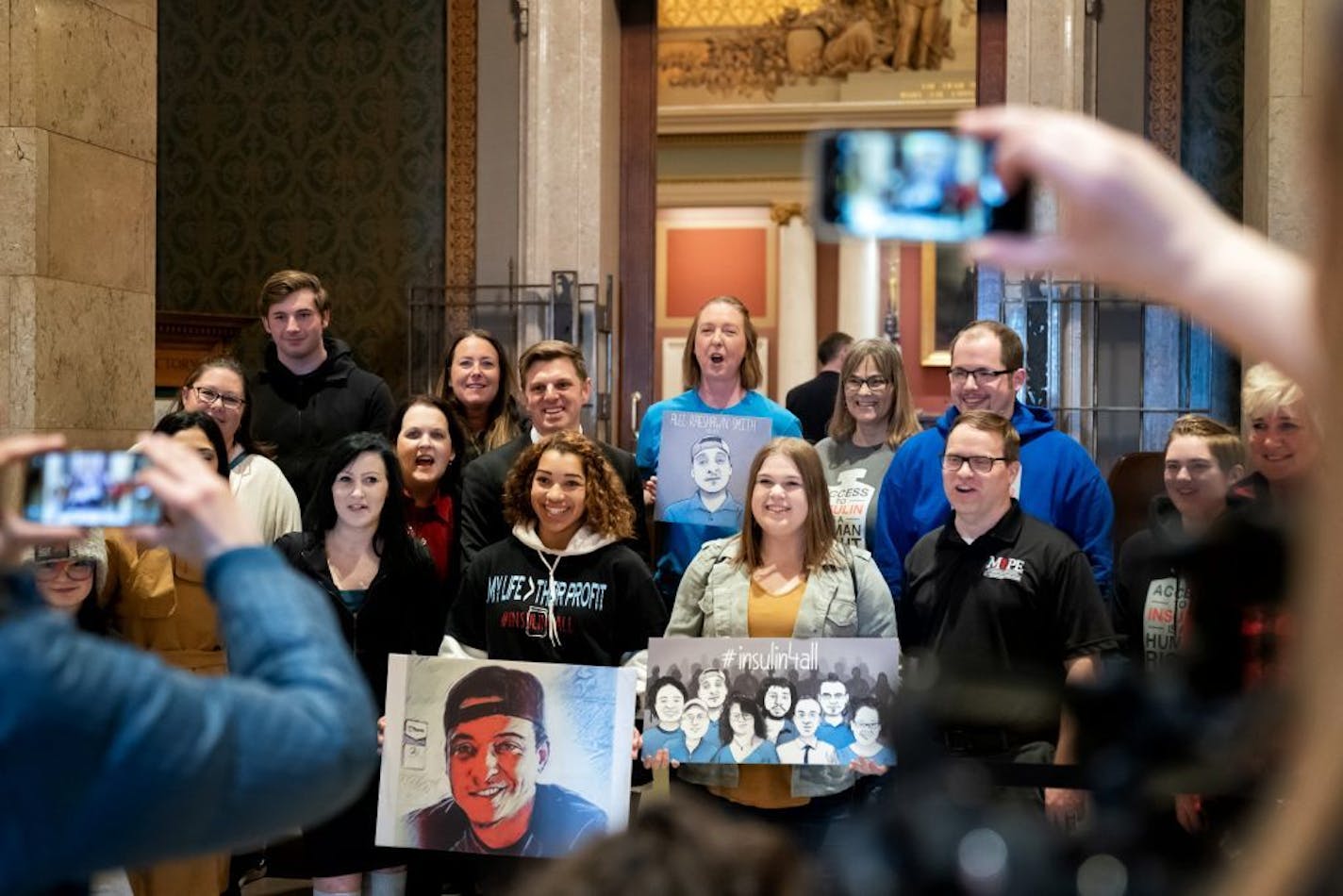 Insulin backers including Nicole Smith-Holt, center, gathered outside the House Chamber to support House members who are expected to pass an emergency insulin package Wednesday night. The bill named after her son Alec who died trying to ration his insulin in 2017.