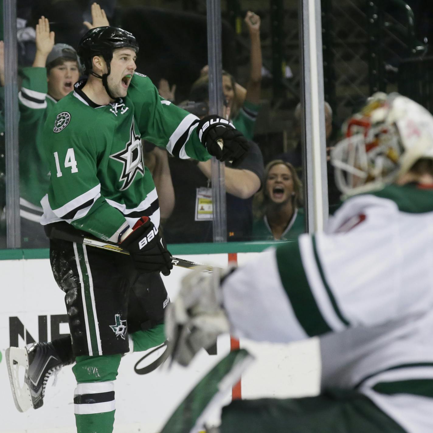 Dallas Stars left wing Jamie Benn (14) celebrates his goal against Minnesota Wild goalie Devan Dubnyk (40) during the third period in Game 2 in the first round of the NHL Stanley Cup playoffs Saturday, April 16, 2016, in Dallas. (AP Photo/LM Otero)