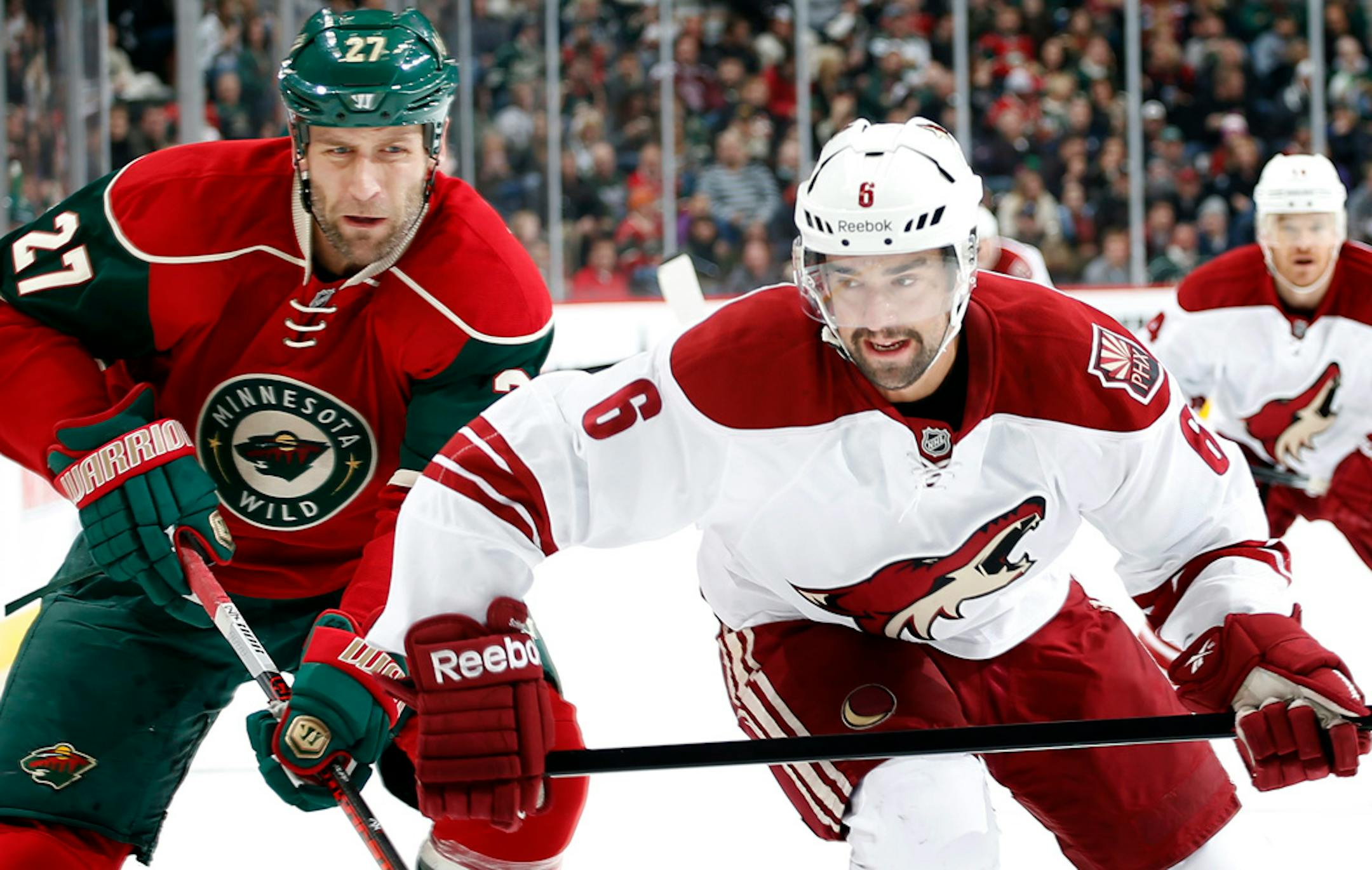Mike Rupp (27) and David Schlemko (6) chased a loose puck the first period.