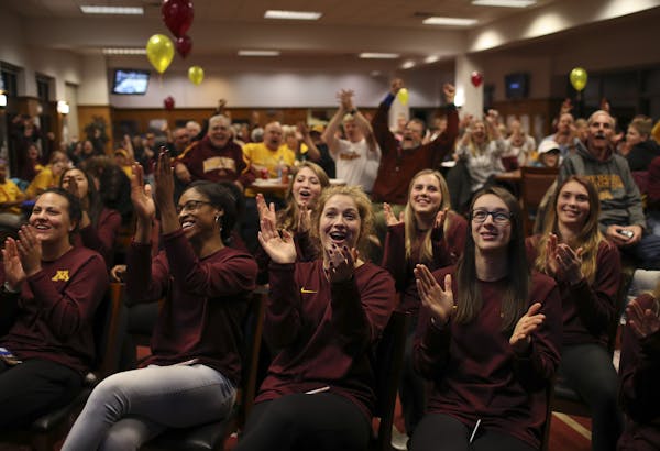 The Gopher volleyball team, including, in the front row, from left, Maddie Beal, Taylor Morgan, Margaret Eggert, and Erica Handley all reacted to the 
