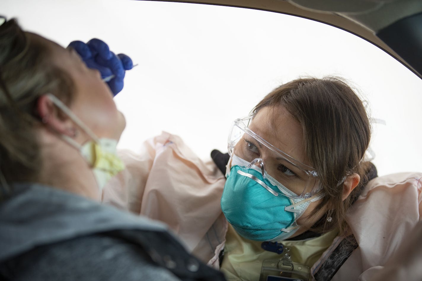 Cheryl Odegaard, a medical assistant at St. Luke's Respiratory Clinic, administered a COVID-19 test to a patient in their drive thru testing site on Thursday. ] ALEX KORMANN • alex.kormann@startribune.com St. Luke's Respiratory Clinic administers an average of 50 COVID-19 tests each day. The testing site saw around that number on Thursday September 24, 2020.