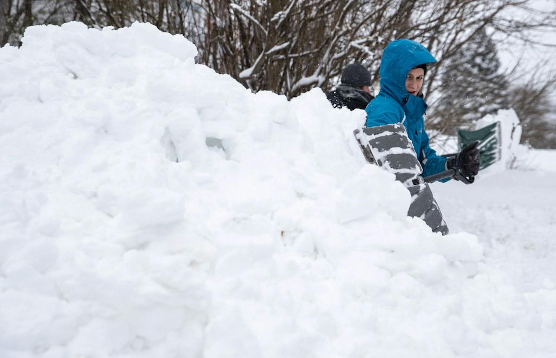 Chrissy Holm shoveled snow from her driveway on Sunday morning. Holm said she and her husband had been outside for nearly two hours trying to clear their small driveway.