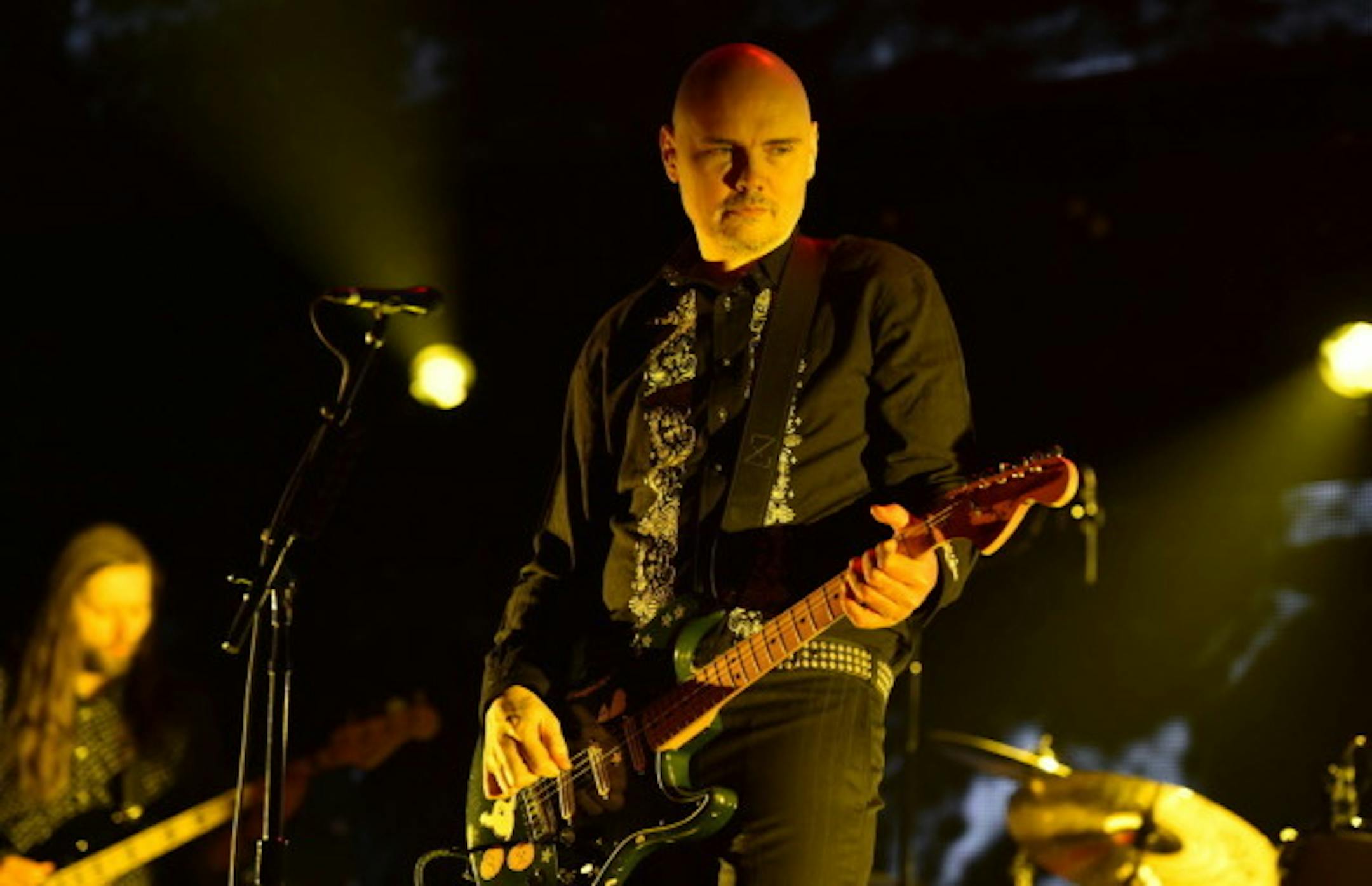 Billy Corgan will hopefully look more interested at Xcel Center in August than he does here when his remade Smashing Pumpkins played Los Angeles's KROQ Christmas concert in 2014. / John Shearer, Invision/AP