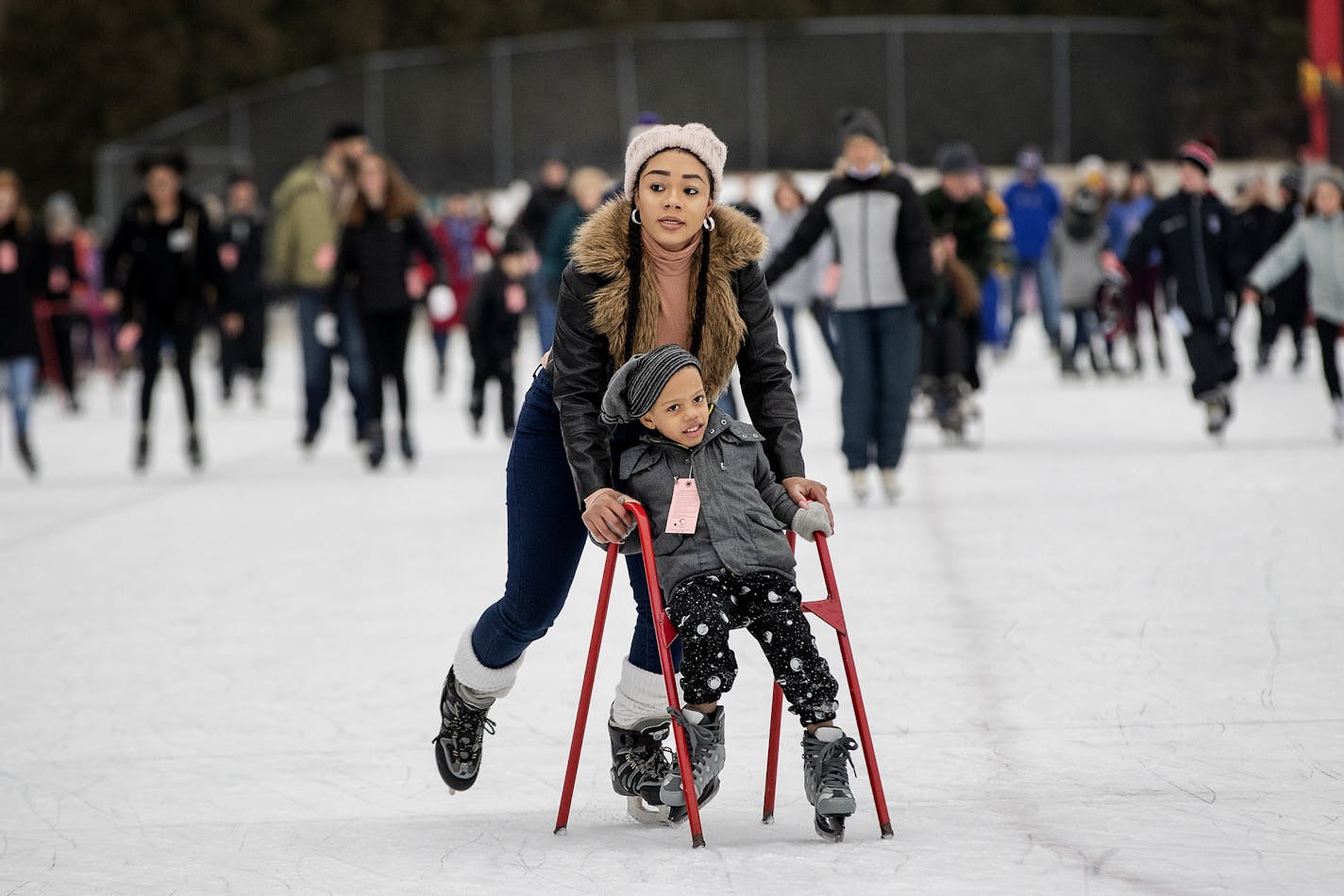 Neosha Thompson pushed her son Ivan, 4, around the Guidant John Rose Minnesota Oval on Wednesday as other skaters cruised behind.