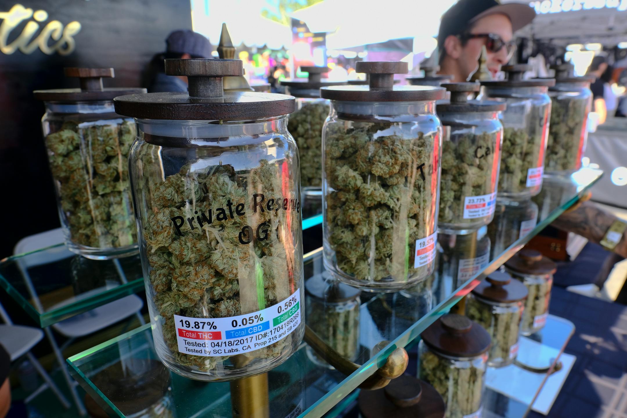 FILE - In this April 23, 2017, file photo, large jars of marijuana are on display for sale at the Cali Gold Genetics booth during the High Times Cannabis Cup in San Bernardino, Calif. California is kicking off recreational marijuana sales on Jan. 1, 2018, but there will be plenty of confusion as the new market takes shape. Some places are banning sales, while only a small number appear ready to issue licenses. (AP Photo/Richard Vogel, File)