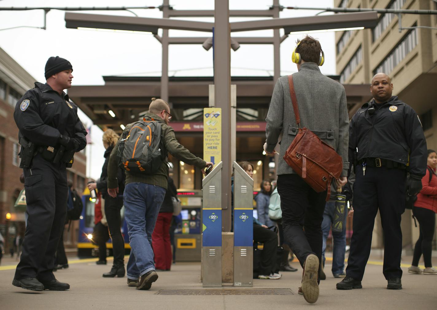 Transit officers Noah LaBathe, left, and LaFayette Temple checked for valid passes or receipts from riders at the East Bank Station Tuesday afternoon in Minneapolis. ] JEFF WHEELER &#xef; jeff.wheeler@startribune.com A new report shows that light rail fare dodgers cost the Met Council about $28,000 a week in lost revenues. Riders rarely see anyone checking for compliance, but Tuesday afternoon, April 7, 2015 Transit Police were at the East Bank station at the U of M asking for proof of payment.