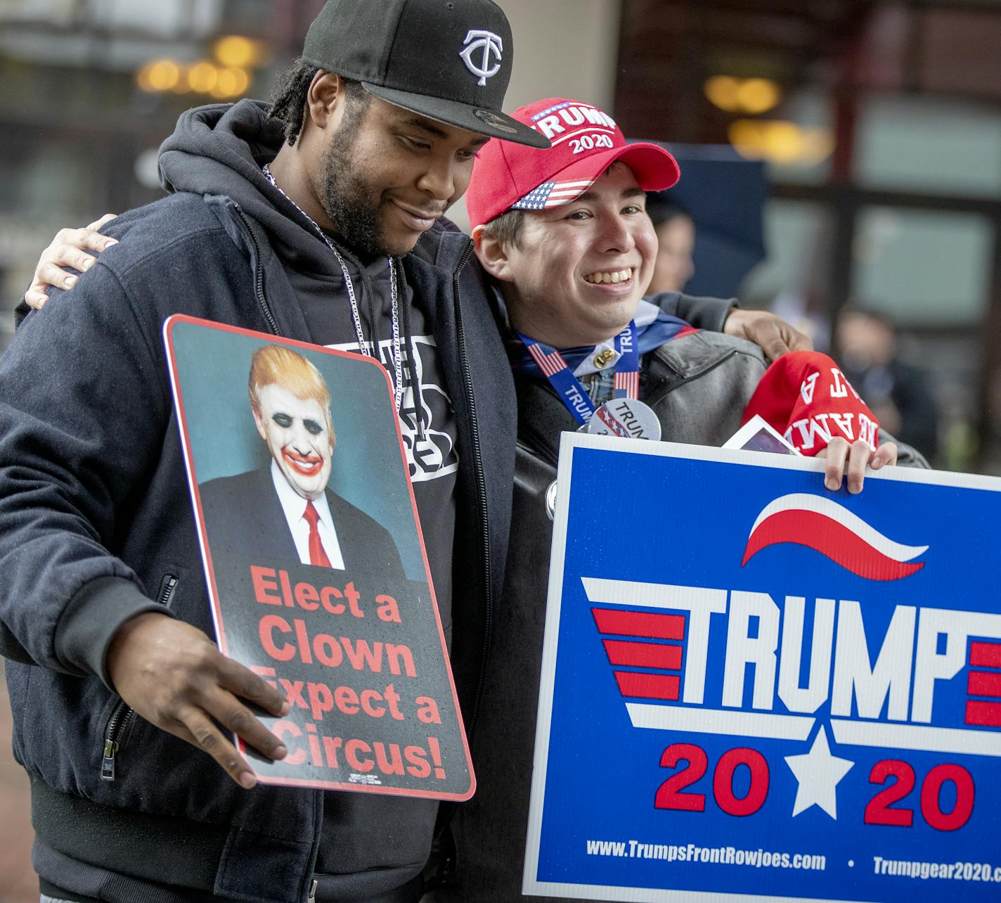 Anti-Trump Willy Jenkins, left, and Trump supporter Chris Windego, right, gave each other a hug as they waited outside the Target Center in preparation for President Trump's visit, Thursday, October 10, 2019 in Minneapolis, MN. ] ELIZABETH FLORES &#x2022; liz.flores@startribune.com