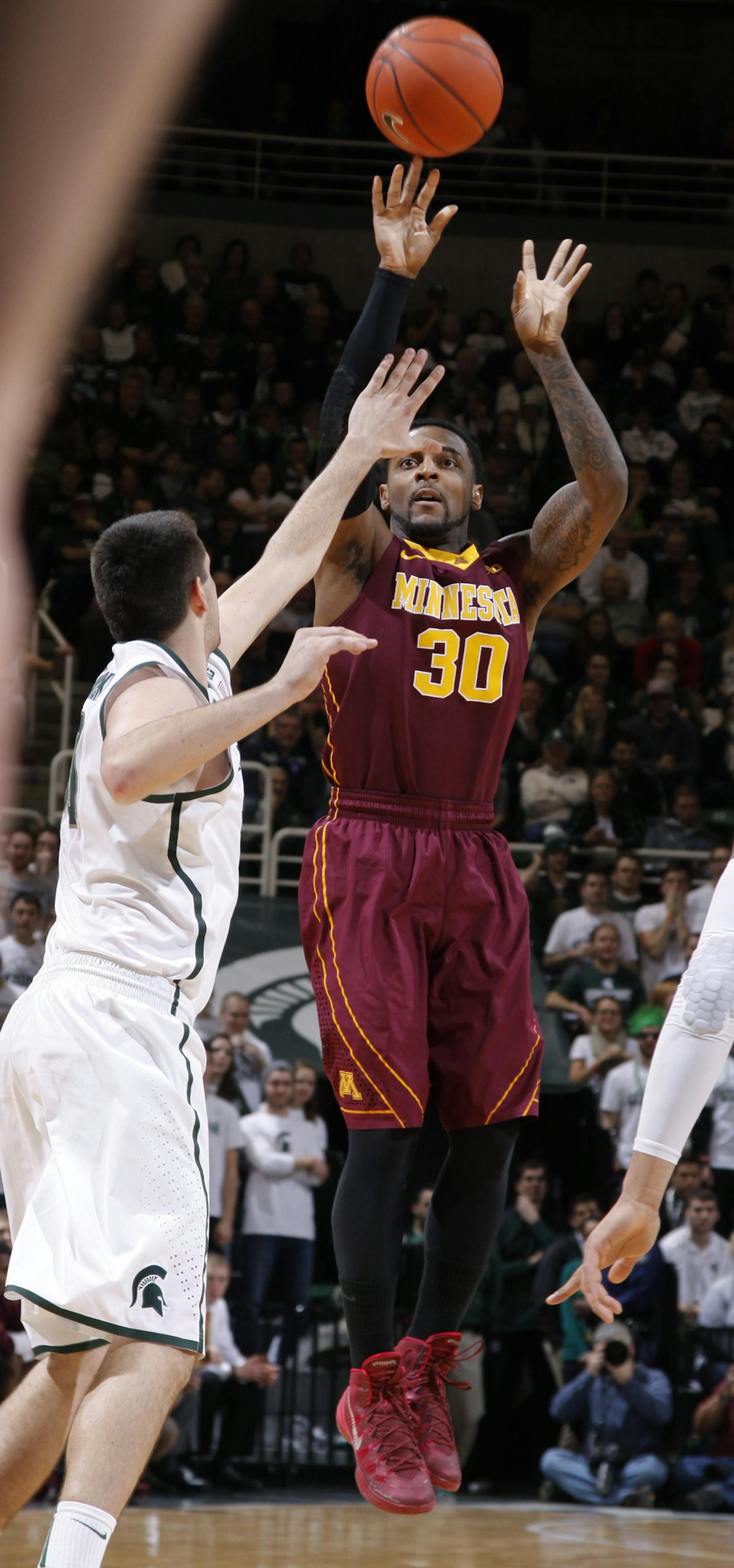 Malik Smith lined up the target and shot over Michigan State’s Kenny Kaminski during the first half. Smith finished with 17 points, second-best on the Gophers.