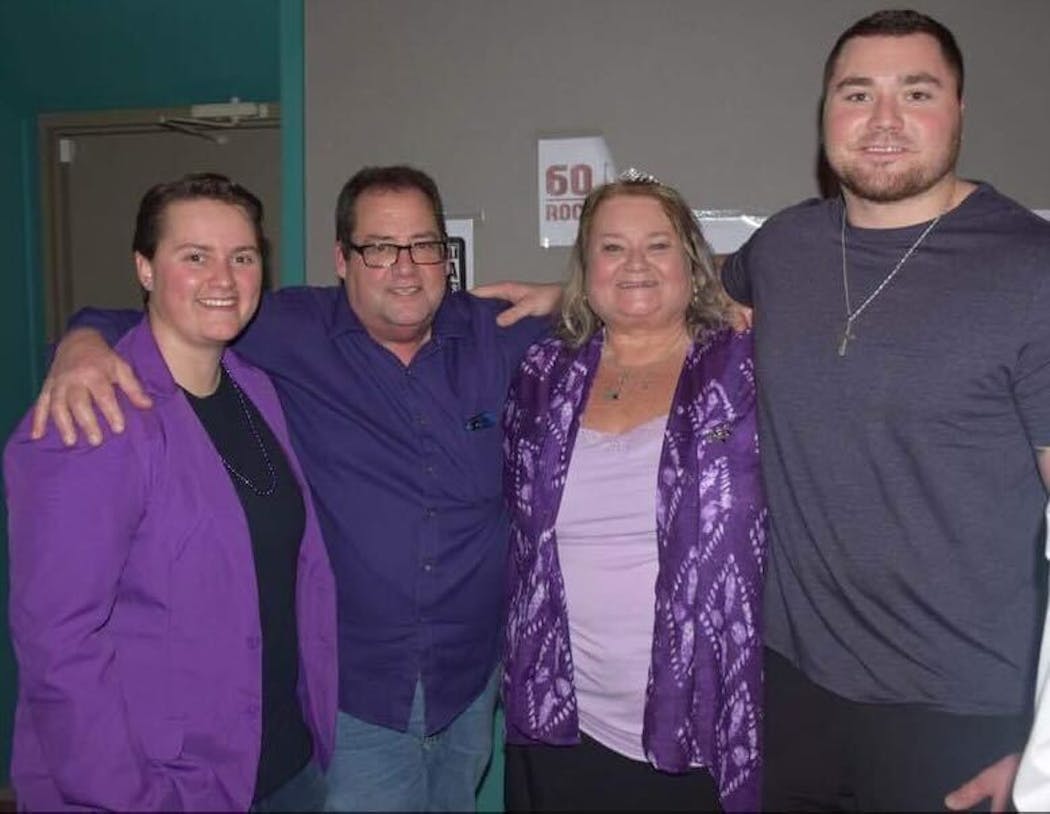 Phillips with his sister, Delanie; his father, Paul; and his mother, Tammie. “Anything purple, we buy,” Tammie said.