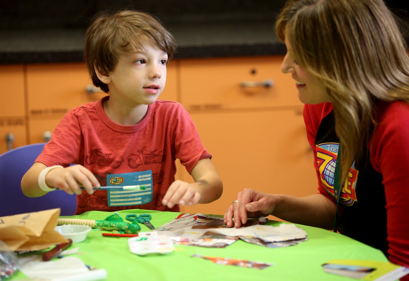 Stephanie Smith, Child Life Specialist, worked with Andrew Naranjo, 5, as he did art projects for himself and his mom. ] (KYNDELL HARKNESS/STAR TRIBUNE) kyndell.harkness@startribune.com Stephanie Smith, Child Life Specialist at Children's Hospital has taken the Life is Good training works with kids. This was shot Wednesday, March 1, 2017 at Children's Hospital in St. Paul, Min.