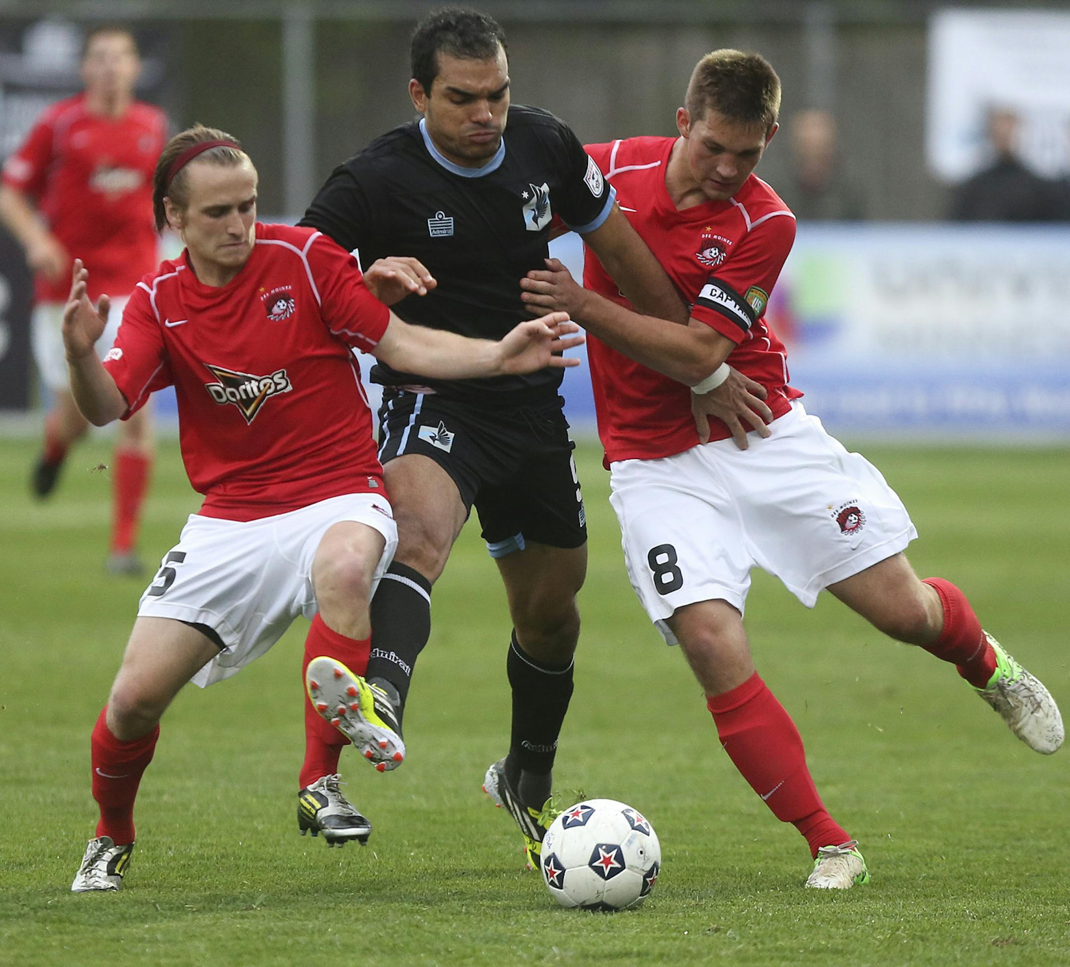Minnesota United's Pablo Campos tried to get through the double team of Des Moines Menace's Brandon Fricke, right, and James Vollmer during the first half at Elizabeth Robie Stadium in St. Paul, Min., Tuesday, May 21, 2013 ] (KYNDELL HARKNESS/STAR TRIBUNE) kyndell.harkness@startribune.com