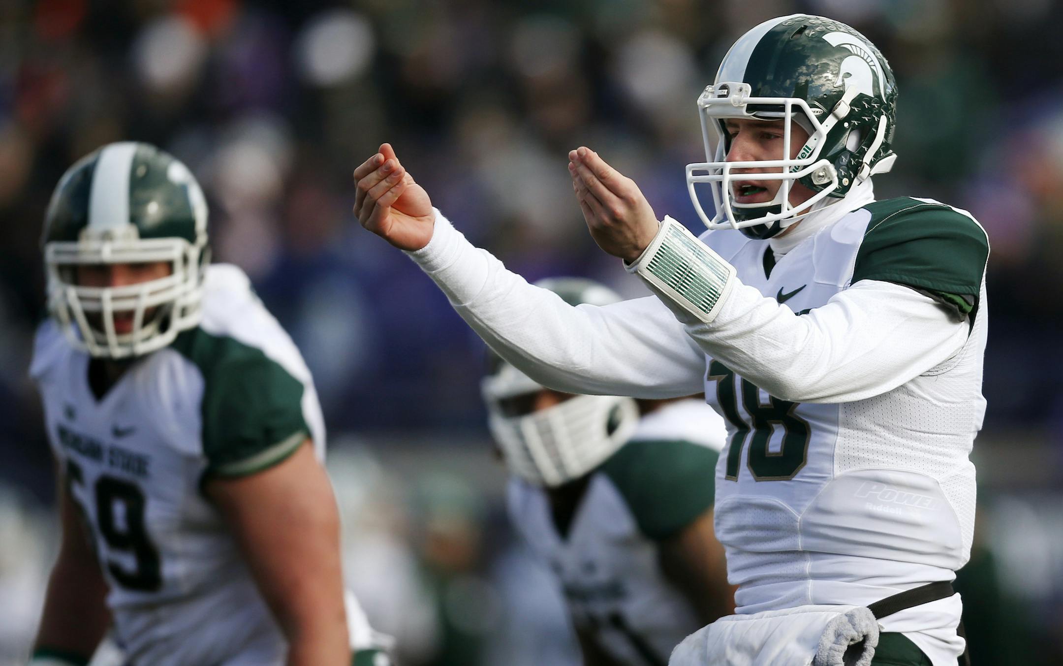 Michigan State quarterback Connor Cook (18) communicates to his team during the first half of an NCAA football game against Northwestern on Saturday, Nov. 23, 2013, in Evanston, Ill. (AP Photo/Andrew A. Nelles)