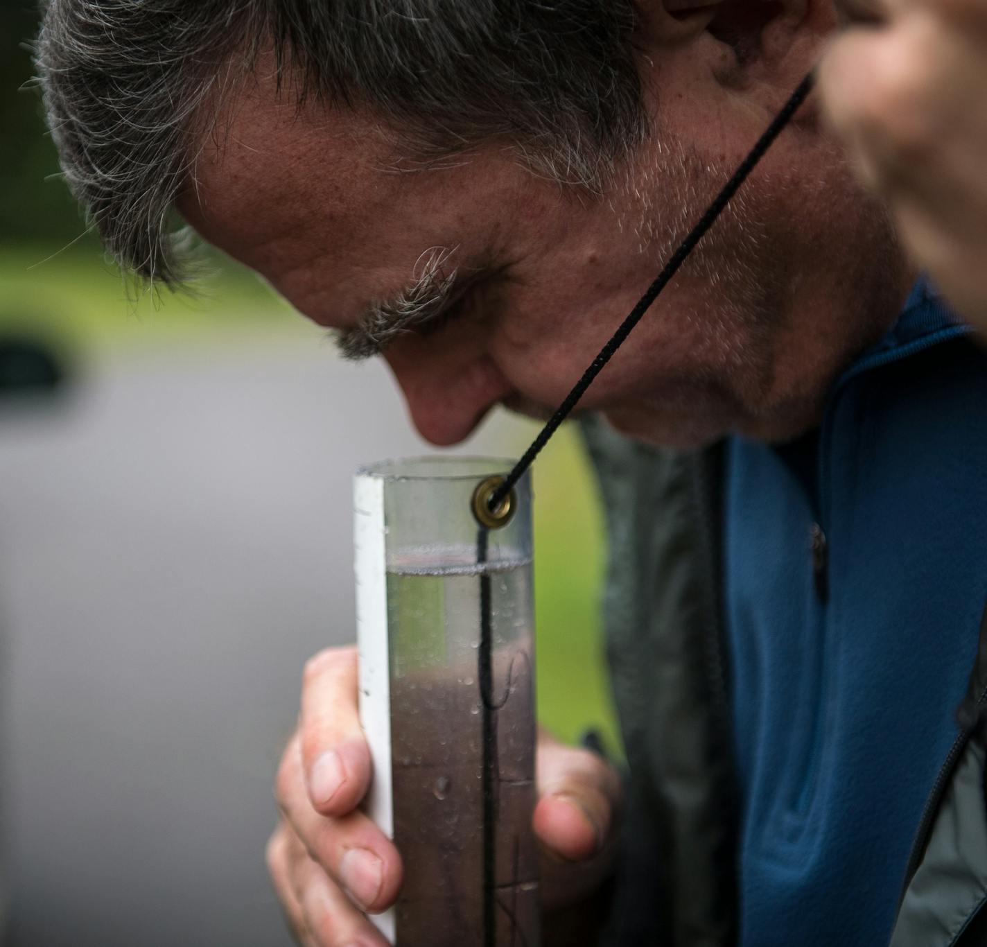 Jim MacArthur, watershed pollutant and load monitor with the Minnesota Pollution Control Agency, used a "t-tube" to check the clarity of a water sample taken out of the Mississippi River at Sauk Rapids Municipal Park in early August. ] (AARON LAVINSKY/STAR TRIBUNE) aaron.lavinsky@startribune.com RIVERS PROJECT: We look at three of Minnesota's rivers, including the Mississippi, Red and Chippewa, to see how land use effects water quality and pollution.