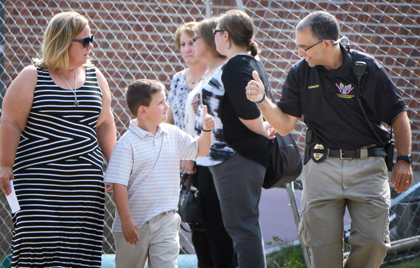 Officer Williams Mathews' son Wyatt got a thumbs-up from family friend and Edina police Sgt. Brian Hubbard as he and mother Shawn entered the Wayzata Free Church at the beginning of the visitation Wednesday.